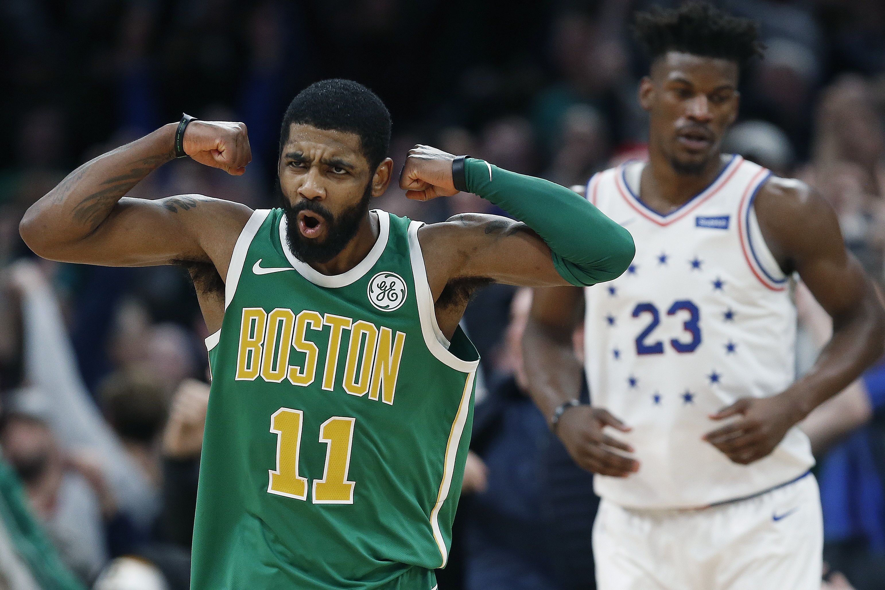 Boston Celtics' Kyrie Irving (11) reacts in front of Philadelphia 76ers' Jimmy Butler after making a 3-pointer in overtime during an NBA basketball game in Boston, Tuesday, Dec. 25, 2018. Boston won 121-114. (AP Photo/Michael Dwyer)  Michael Dwyer