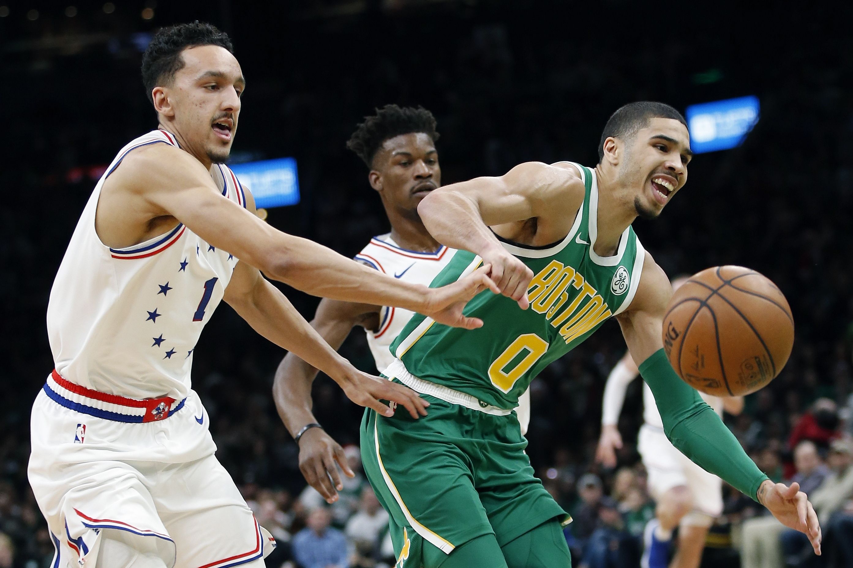 Boston Celtics' Jayson Tatum (0) and Philadelphia 76ers' Landry Shamet (1) can't come up with a loose ball during the first half of an NBA basketball game in Boston, Tuesday, Dec. 25, 2018. (AP Photo/Michael Dwyer)  Michael Dwyer