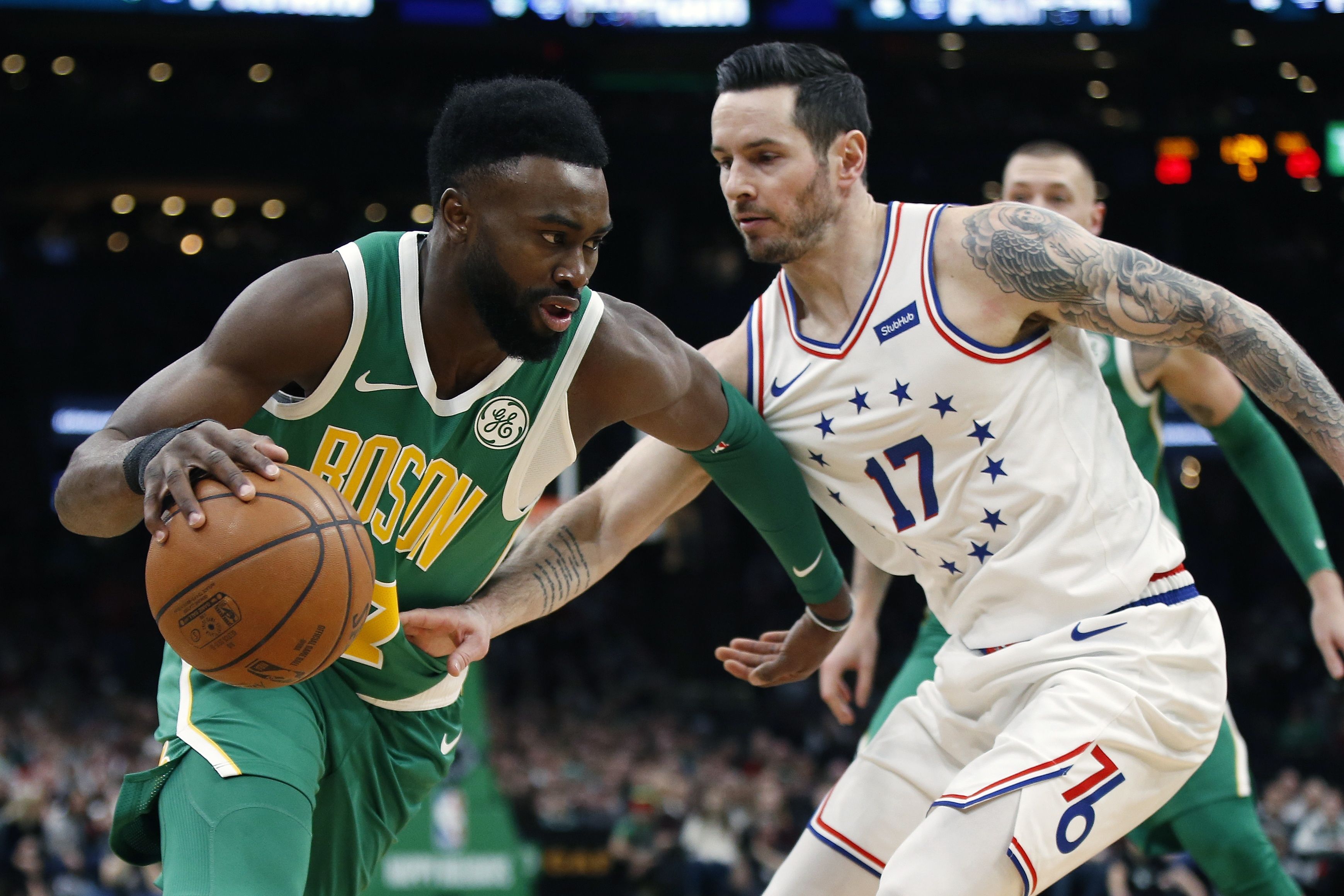 Boston Celtics' Jaylen Brown (7) is defended by Philadelphia 76ers' JJ Redick (17) during the first half of an NBA basketball game in Boston, Tuesday, Dec. 25, 2018. (AP Photo/Michael Dwyer)  Michael Dwyer