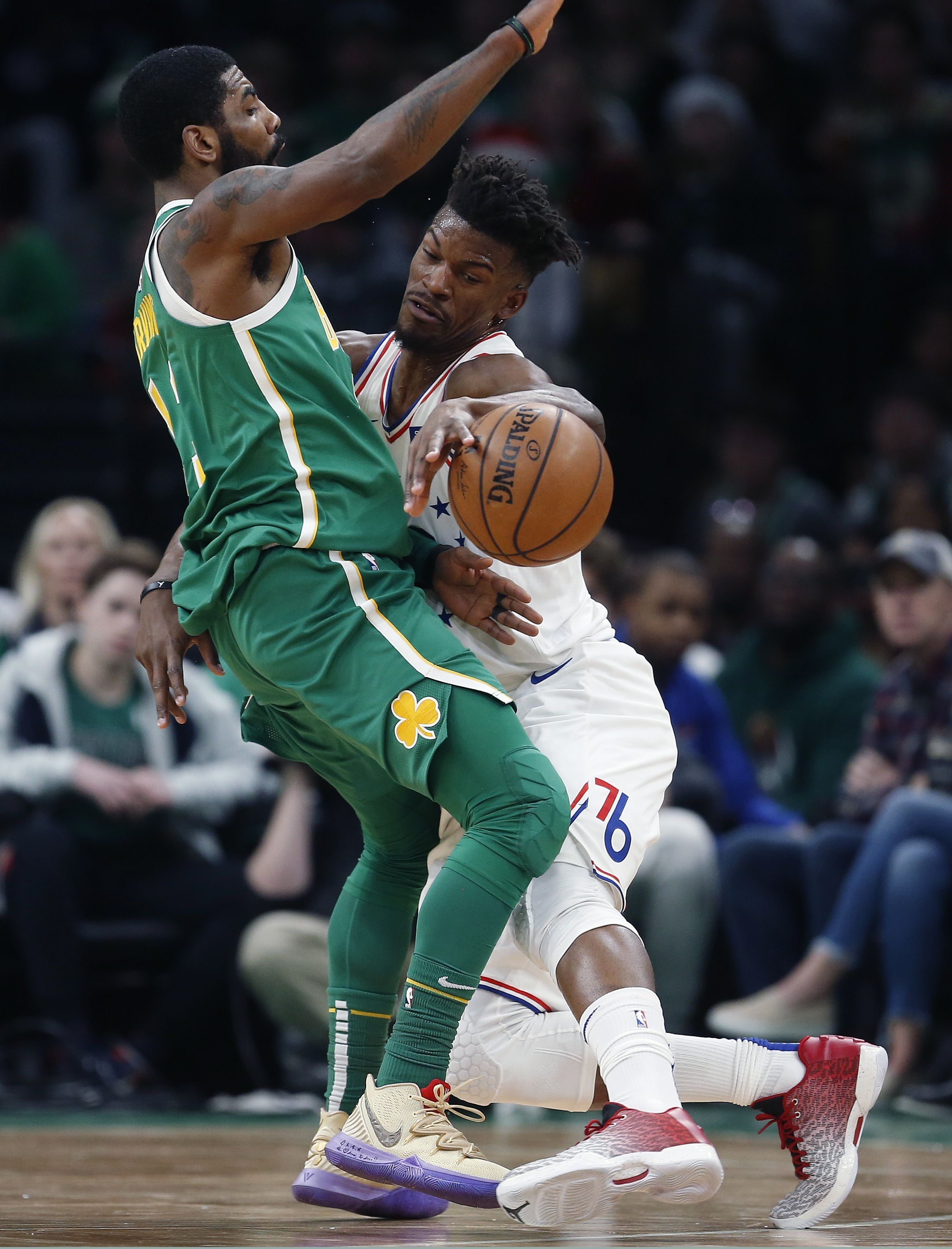 Philadelphia 76ers' Jimmy Butler, right, fouls Boston Celtics' Kyrie Irving during the first half of an NBA basketball game in Boston, Tuesday, Dec. 25, 2018. (AP Photo/Michael Dwyer)  Michael Dwyer