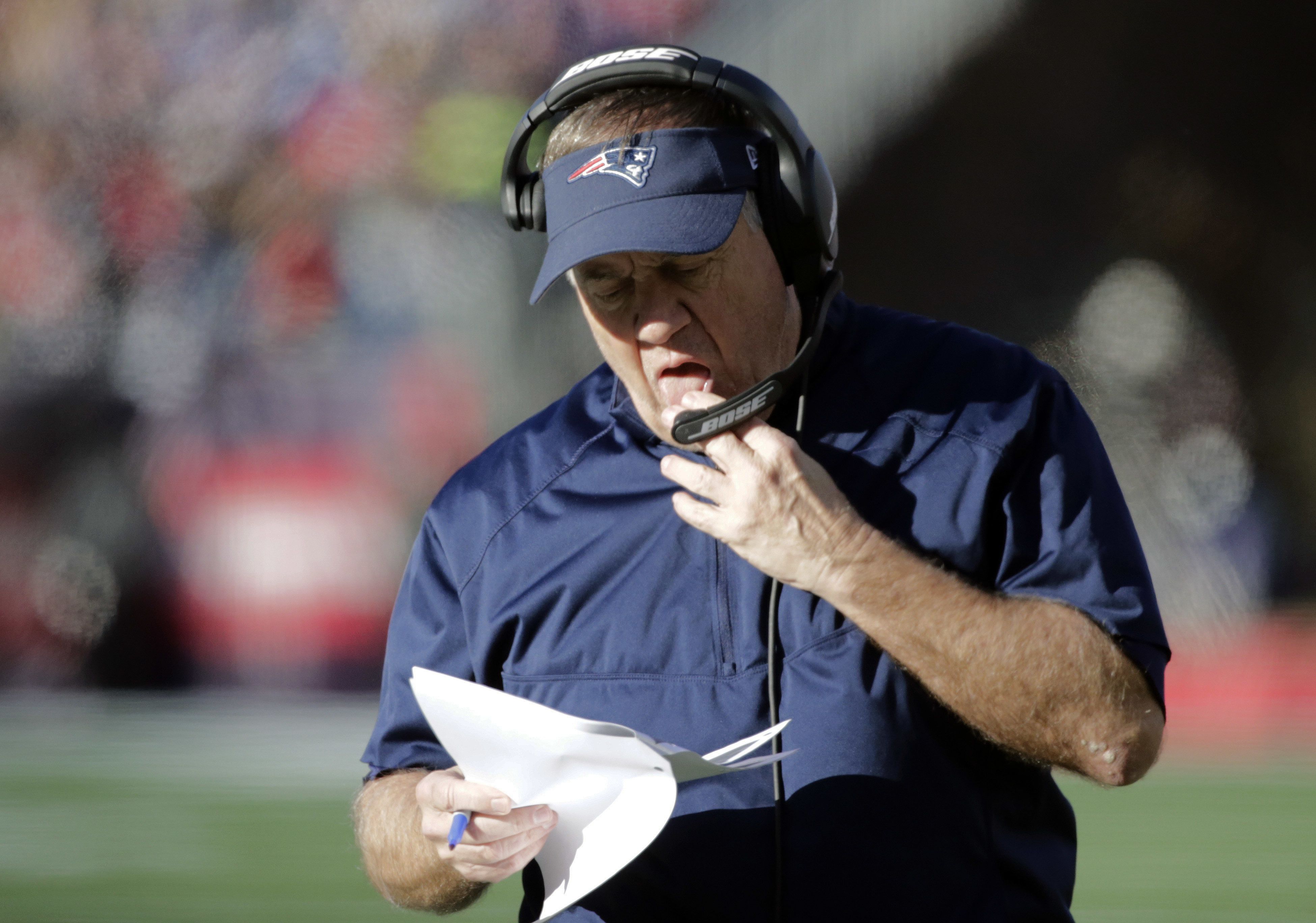 New England Patriots head coach Bill Belichick studies notes on the sideline during the first half of an NFL football game against the Buffalo Bills, Sunday, Dec. 23, 2018, in Foxborough, Mass. (AP Photo/Elise Amendola)  Elise Amendola