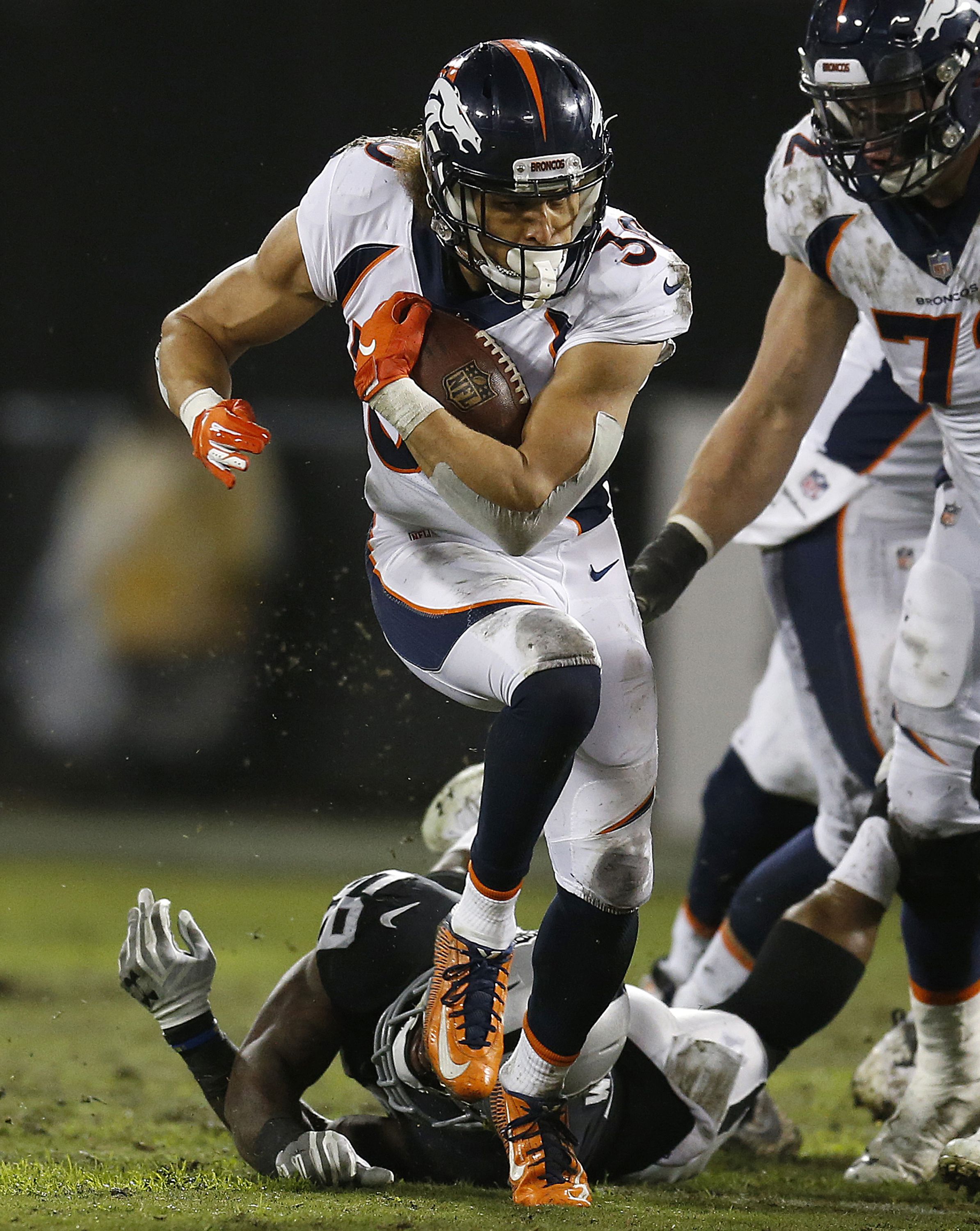 Denver Broncos running back Phillip Lindsay runs against the Oakland Raiders during the first half of an NFL football game in Oakland, Calif., Monday, Dec. 24, 2018. (AP Photo/D. Ross Cameron)  D. Ross Cameron