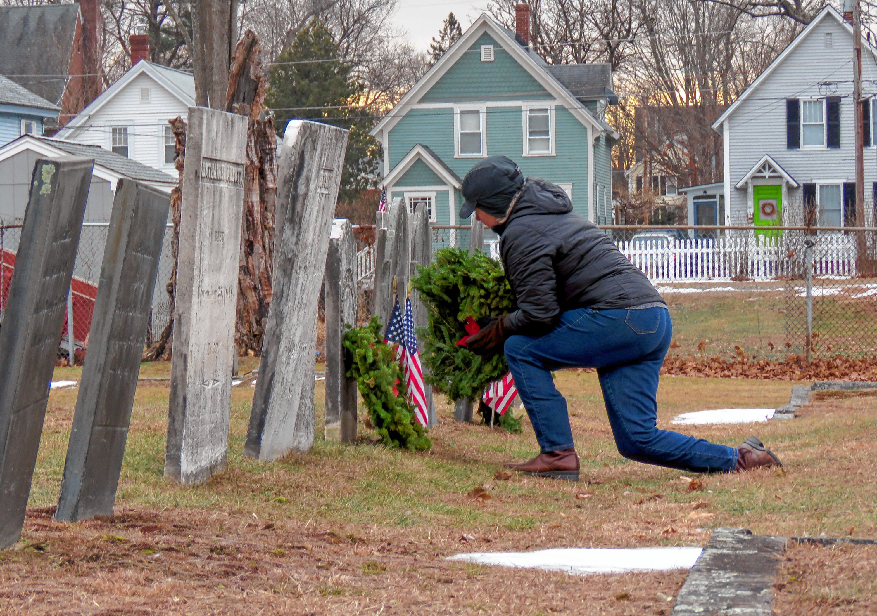 Pierce Brigade member Ginny Friburg lays a wreath on a veteran's grave ...