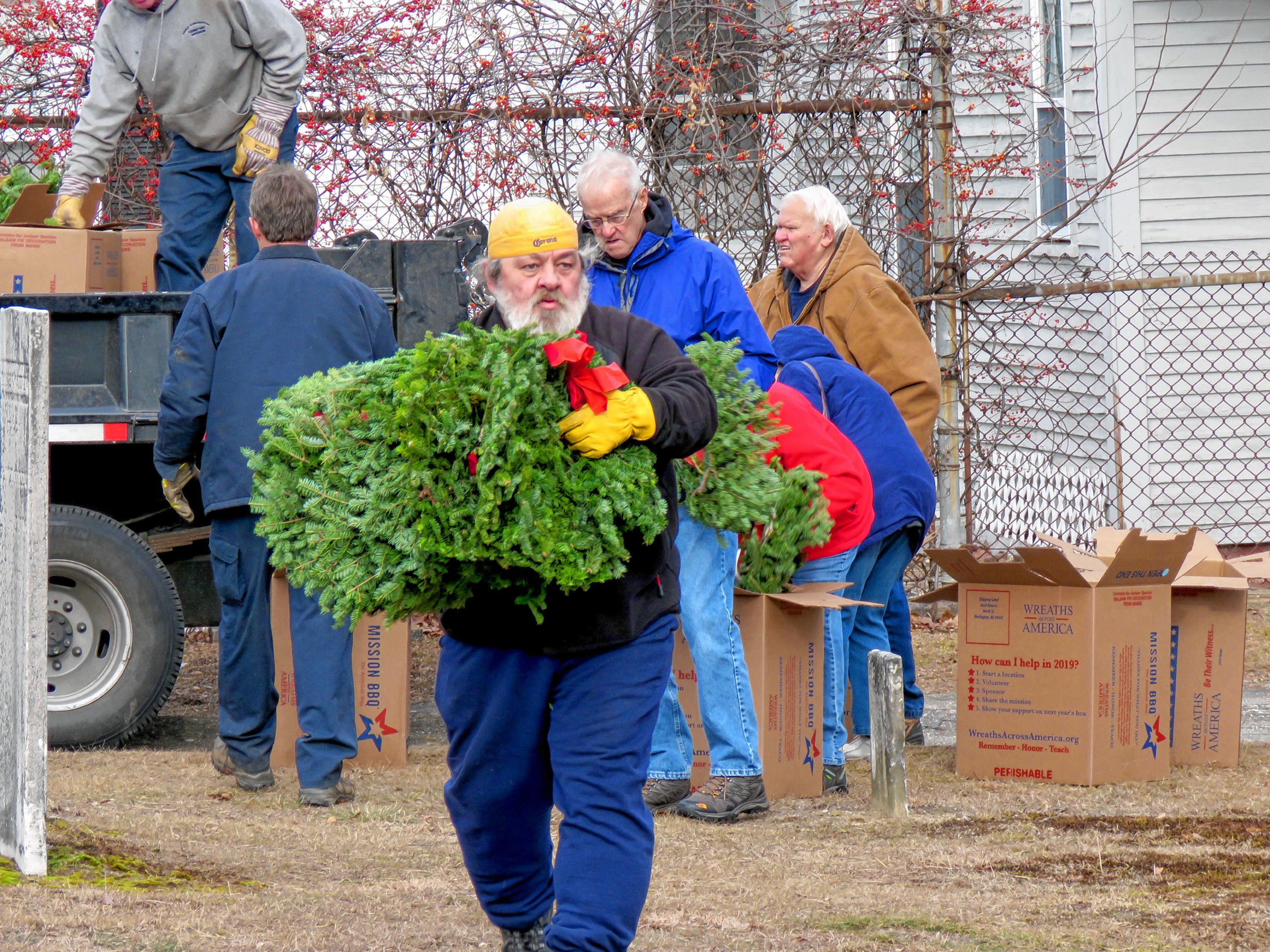 Matthew Wieczhalek-Seiler prepares to lay wreaths at veteran graves in Old North Cemetery in Concord Friday morning. Caitlin Andrews