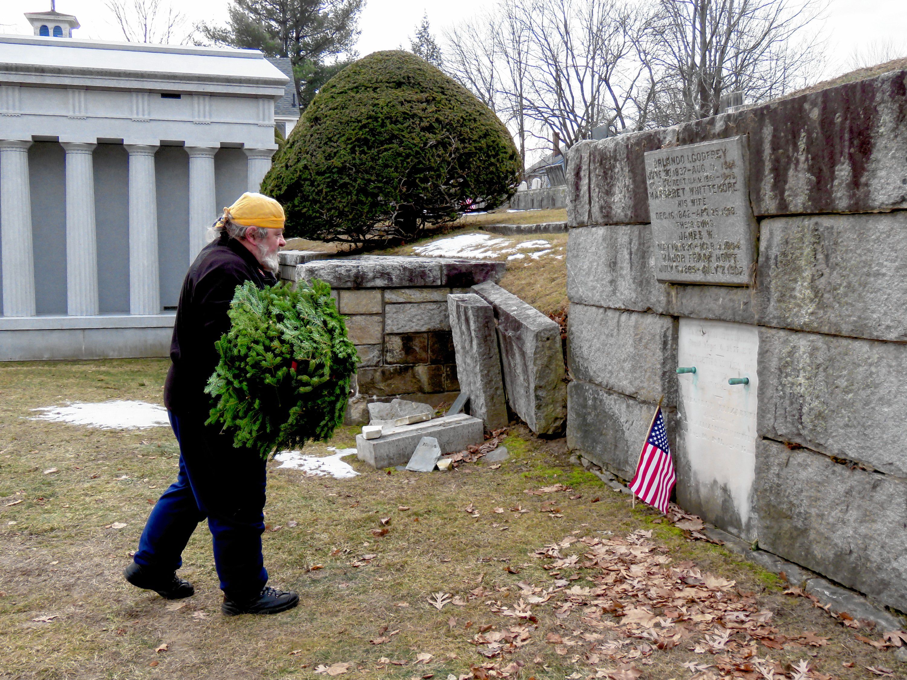 Matthew Wieczhalek-Seiler prepares to lay wreaths at veteran graves in Old North Cemetery in Concord Friday morning. Caitlin Andrews