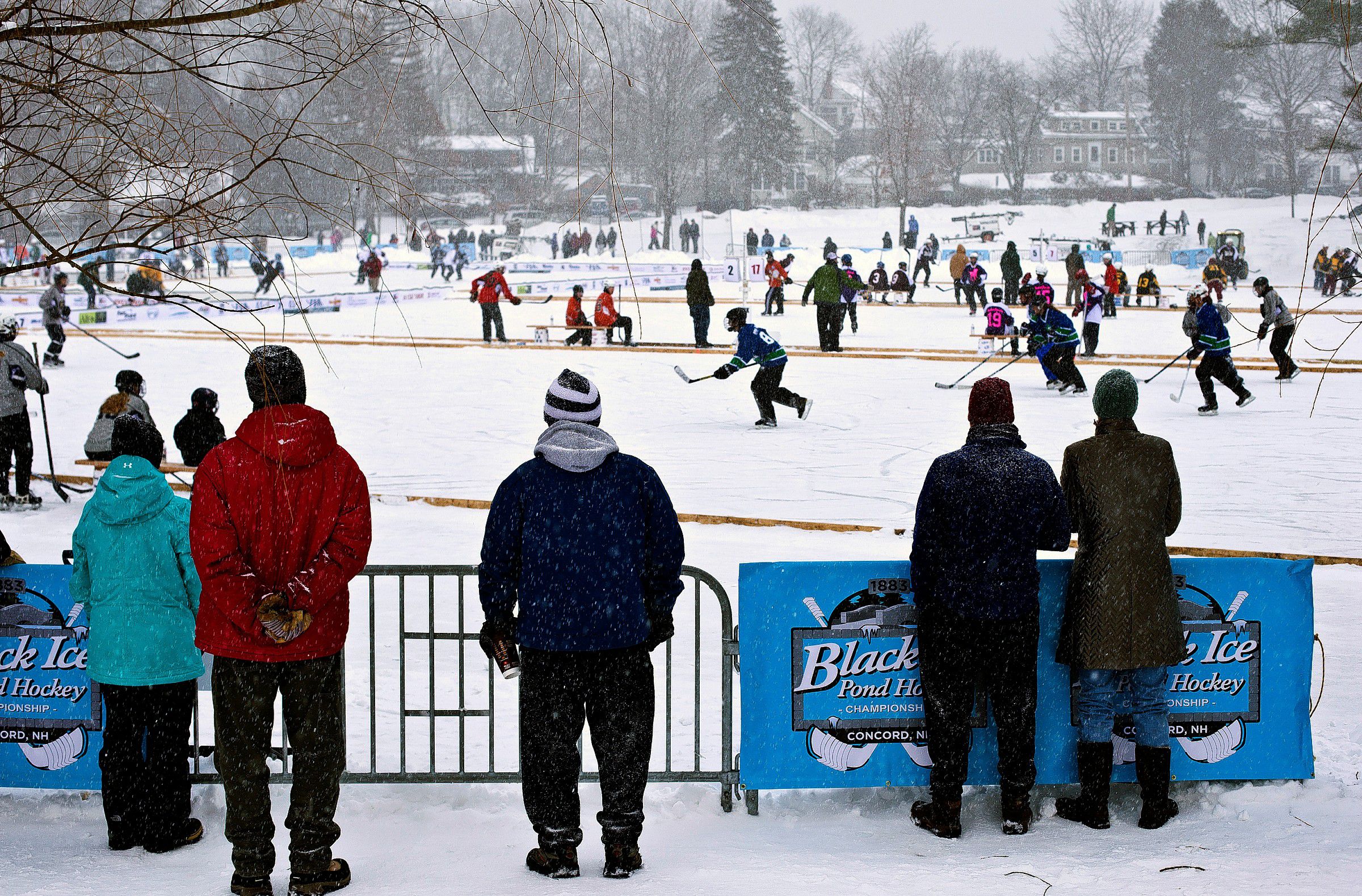 A  snow squall hit just as the semi-finals started at the 5th annual Black Ice Pond Hockey Championship at White Park Sunday morning. The Black Ice Pond Hockey Association, a non-profit entity started in 2010 created this event to help honor the rich heritage of hockey in Concord and to give money back to the communtiy for hockey programs and eventually to replace the indoor warming house at White Park.  (GEOFF FORESTER / Monitor staff) 