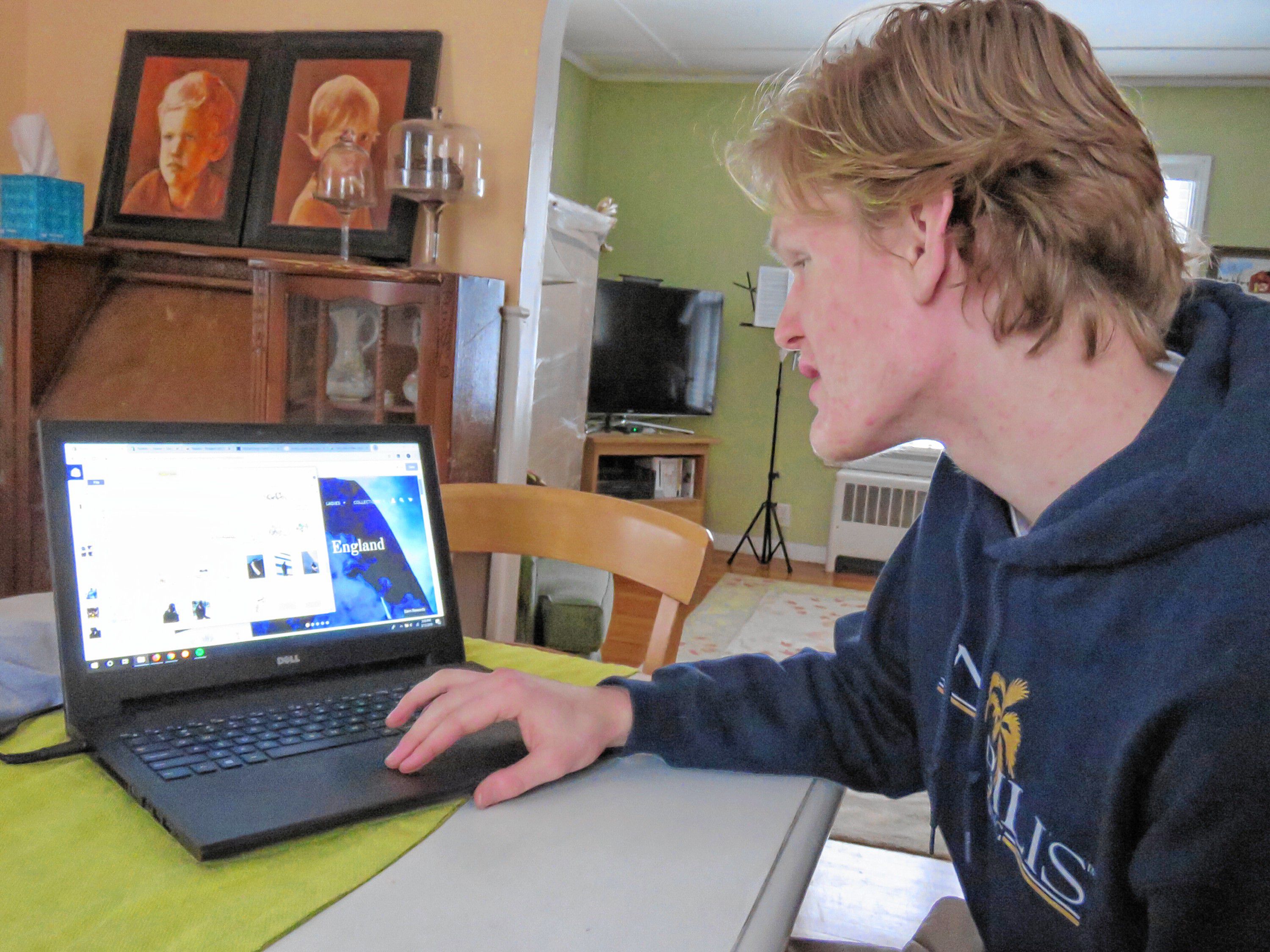 Bishop Brady senior Scott Franklin scrolls through his designs folder on his computer at his home in Conocrd on February 13, 2019. Franklin owns Nobilis, a clothing company he started out of his home that riffs on streetwear and surfer styles. Caitlin Andrews