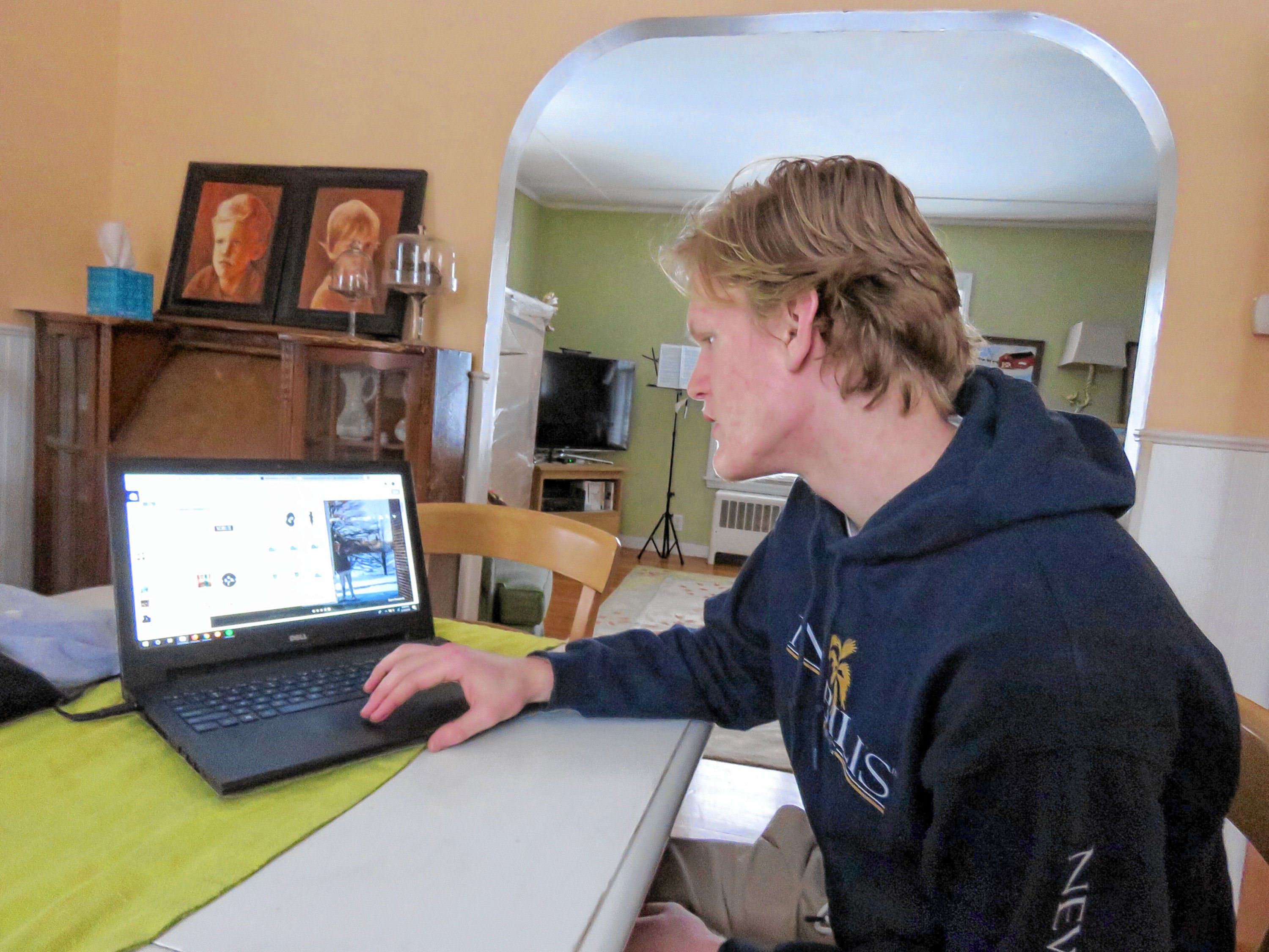 Bishop Brady senior Scott Franklin scrolls through his designs folder on his computer at his home in Conocrd on February 13, 2019. Franklin owns Nobilis, a clothing company he started out of his home that riffs on streetwear and surfer styles. Caitlin Andrews