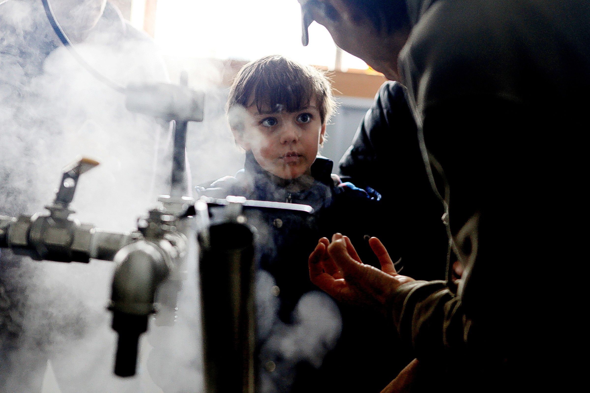 James Russell of Concord, 8, listens to Stefan Lillios explain how to make maple syrup in the boiling room at Maple Ridge Sugar House in Loudon on Saturday, March 22, 2014.  Visitors could see maple syrup being made, tour the farm, visit with a horse, a cow and pigs and taste maple treats.  (ARIANA van den AKKER / Monitor staff) James Russell, 8, of Concord, listens to Stefan Lillios explain how to make maple syrup in the boiling room at Maple Ridge Sugar House in Loudon yesterday. Visitors could watch maple syrup being produced, tour the farm, visit with a horse, a cow and pigs, and taste maple treats. Ariana van den Akker