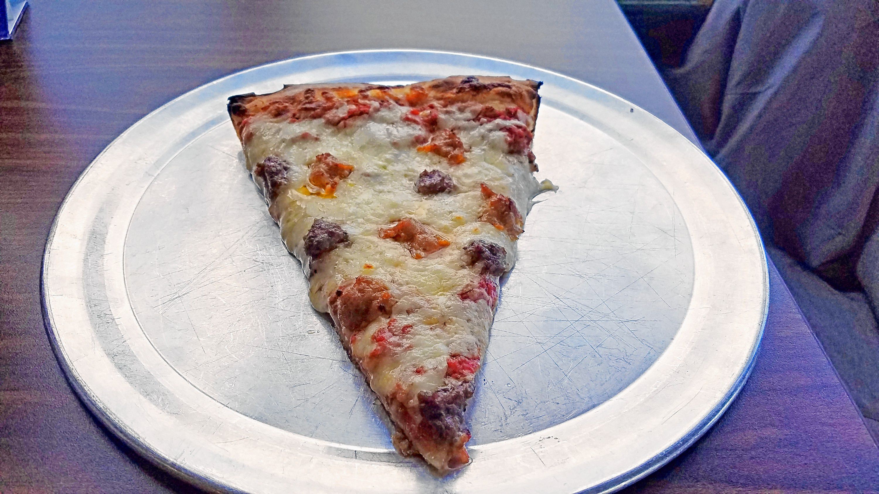 A slice of sausage and hamburger pizza from Vinnie's. JON BODELL / Insider staff