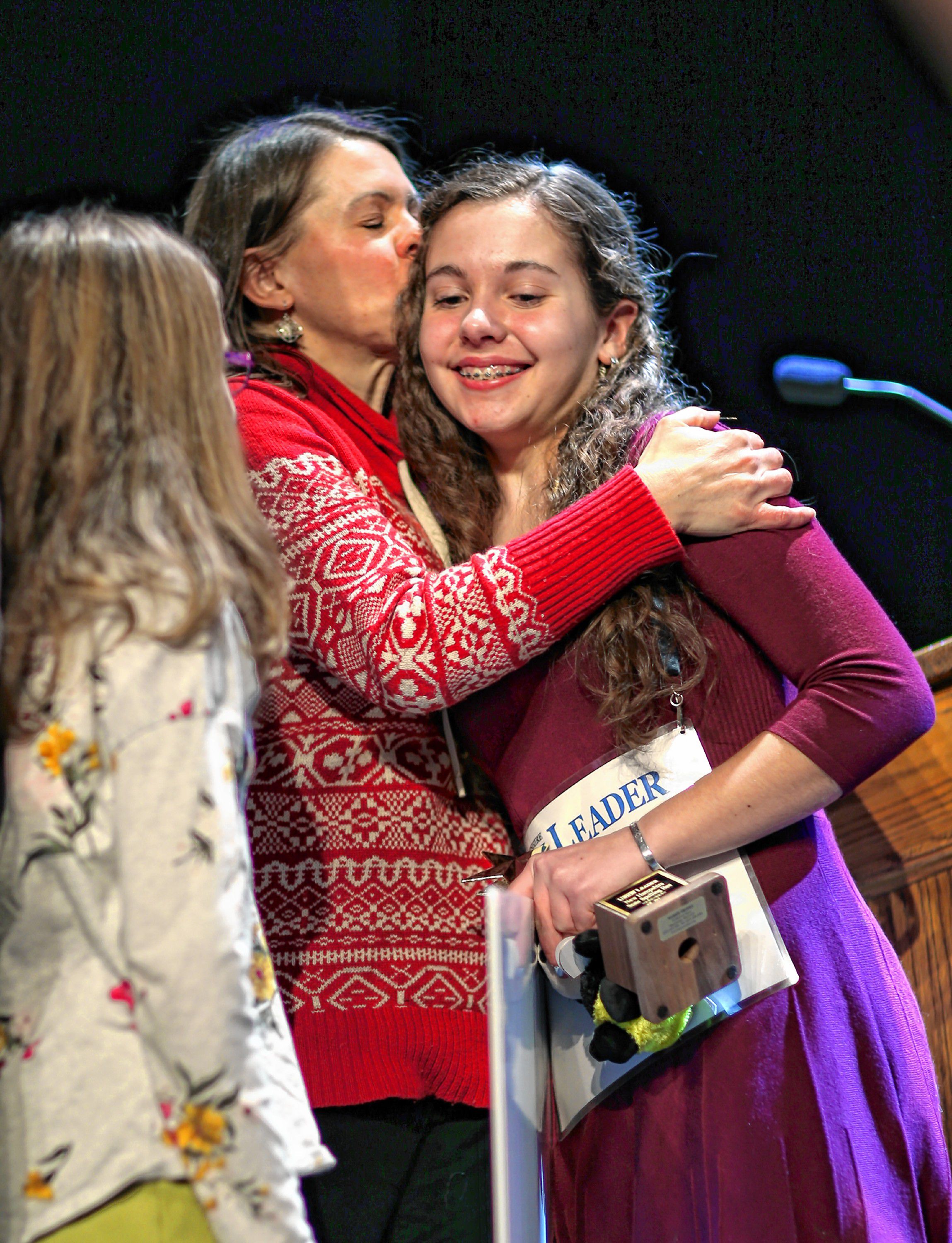 Anna Hammer from Timberline Regional Middle School gets a kiss from her mother Amy after winning the 2019 State Spelling Bee at the Capitol Center for the Arts on Saturday, February 23, 2019. The contest is preliminary to the Scripps National Spelling Bee and was sponsored by the Union Leader. Hammer is from Danville. âIt feels amazing. I didnât even pass the preliminary test last year so this feels great.â  GEOFF FORESTER