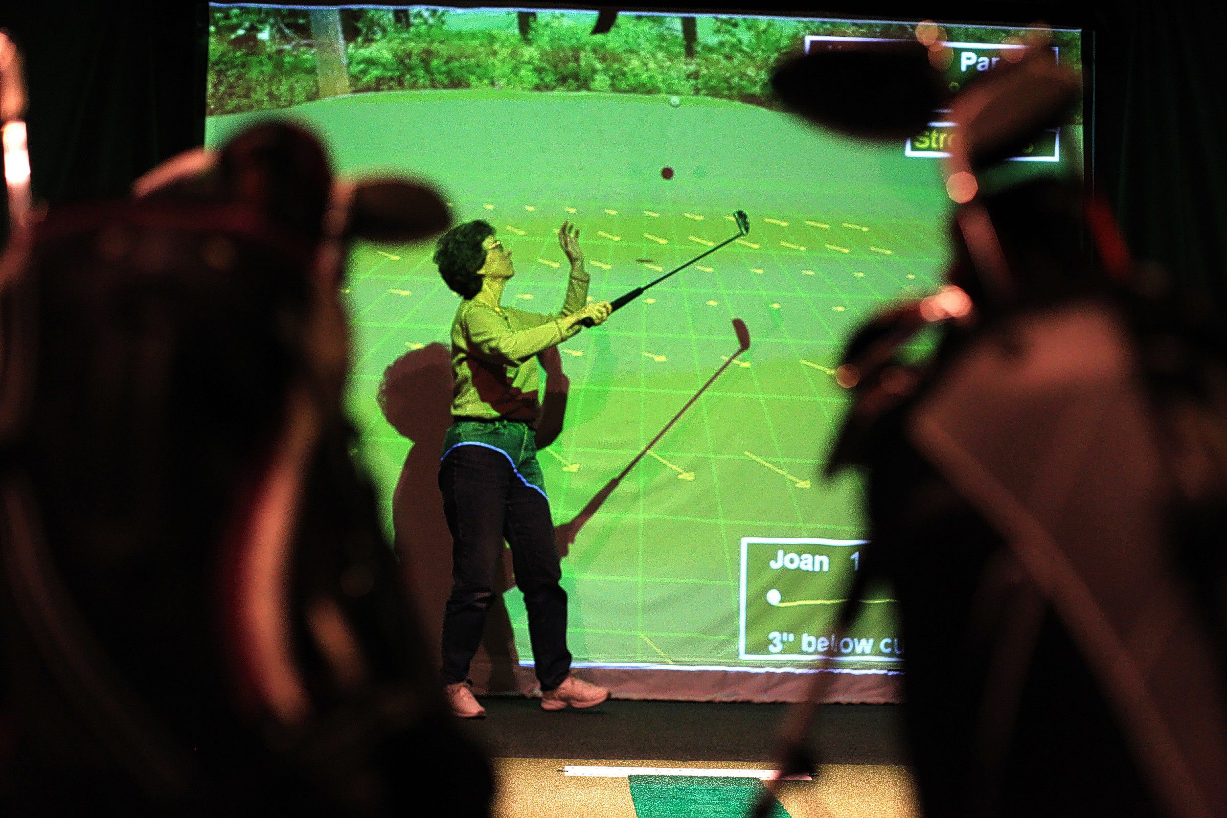 Cindy Brown tosses the ball in the air with her putter to retrieve it while playing virtual golf with Michelle Jackson, Joan Jenkins and Mary Straight inside the restaurant at the Loudon Country Club on Monday, February 24, 2014.  The four women met playing golf and regularly play during the regular golf season.  The four are currently playing in the country club's four-week indoor virtual "tune-up" league.  Virtual golf is new to the country club this year and features a giant screen and sensors that simulate real courses throughout the world.  This week's course was Edgewood at Tahoe.   (ARIANA van den AKKER / Monitor staff)  Cindy Brown tosses the ball in the air with her putter to retrieve it while playing virtual golf with Michelle Jackson, Joan Jenkins and Mary Straight inside the restaurant at the Loudon Country Club on Monday. The four women met playing golf and regularly play during the golf season. The four are playing in the country club’s four-week indoor virtual “tune-up” league. Virtual golf is new to the country club this year and features a giant screen and sensors that simulate real courses throughout the world.  This week’s course was Edgewood Tahoe in California.         Ariana van den Akker