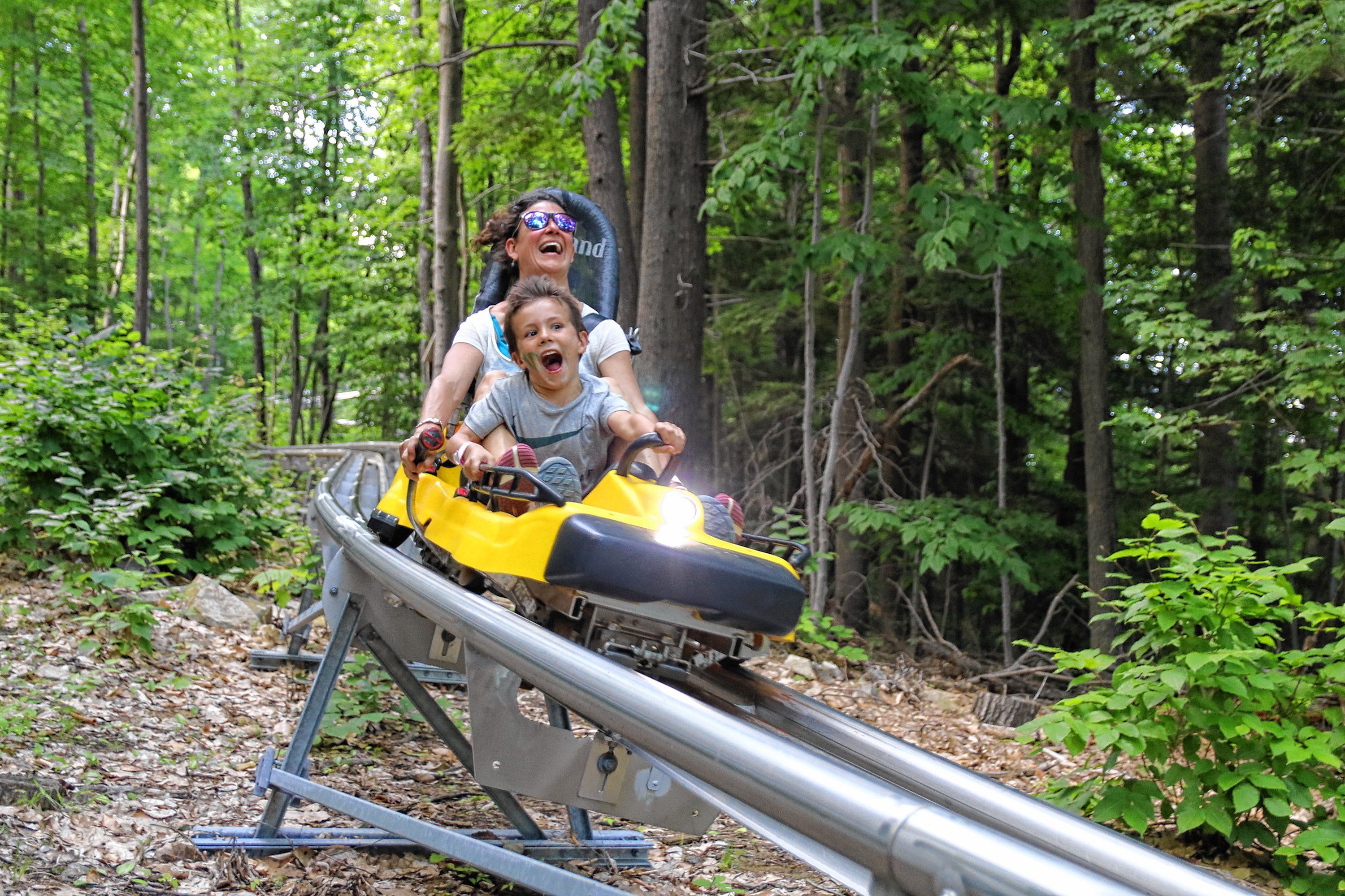 One of the more exciting attractions at Gunstock is the mountain coaster, which lets you control your own speed (to some extent) as you cruise your way down the mountain. Gunstock marketing manager Rachel Templar and her son Oliver seem to be having a blast trying it out. Courtesy of Rachel Templar / Gunstock Mountain Resort