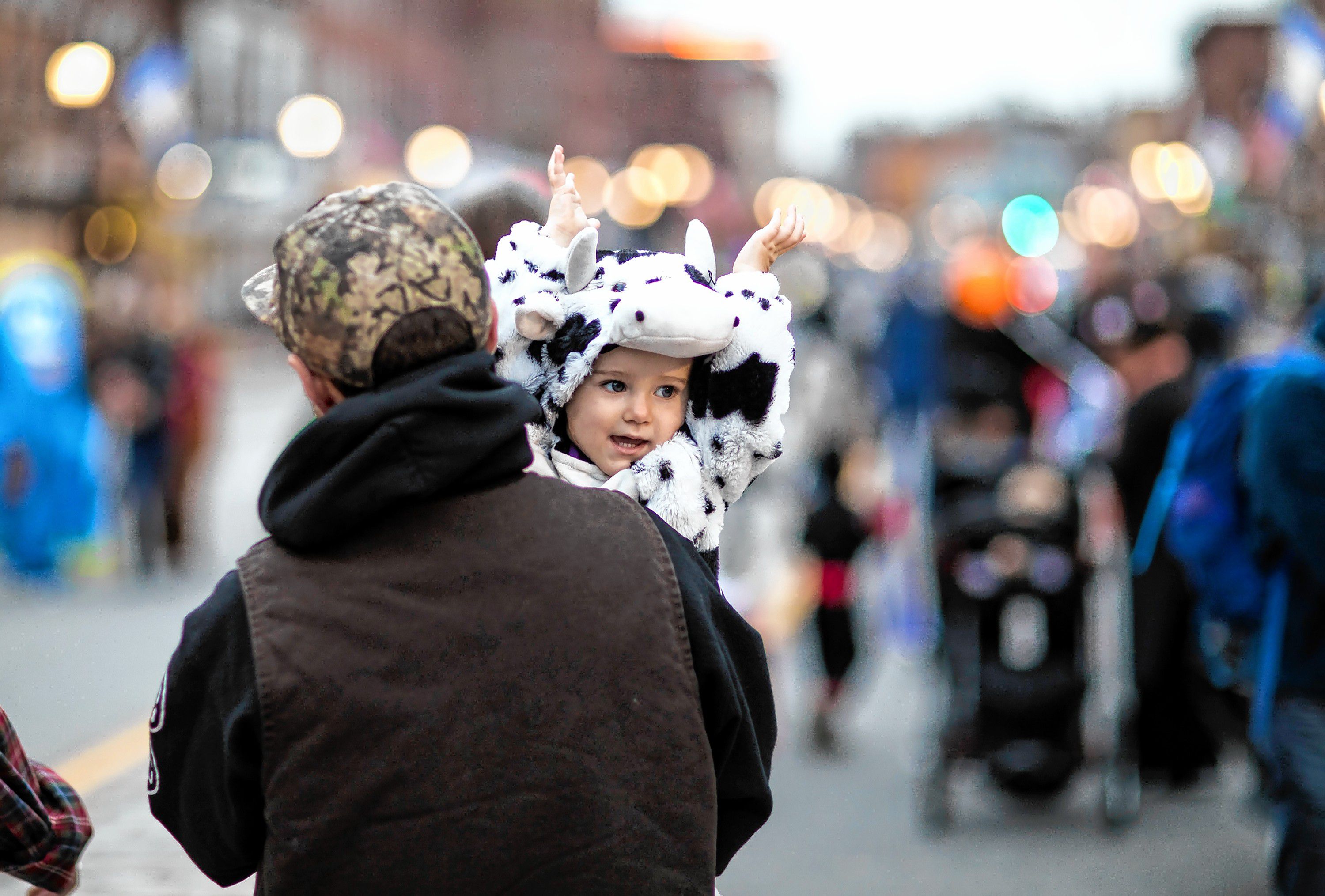 Lumin Perron, 2, in her cow costume walks down Main Street in Concord with her dad Taylor during the Halloween Howl on Friday evening, October 25, 2019. GEOFF FORESTER