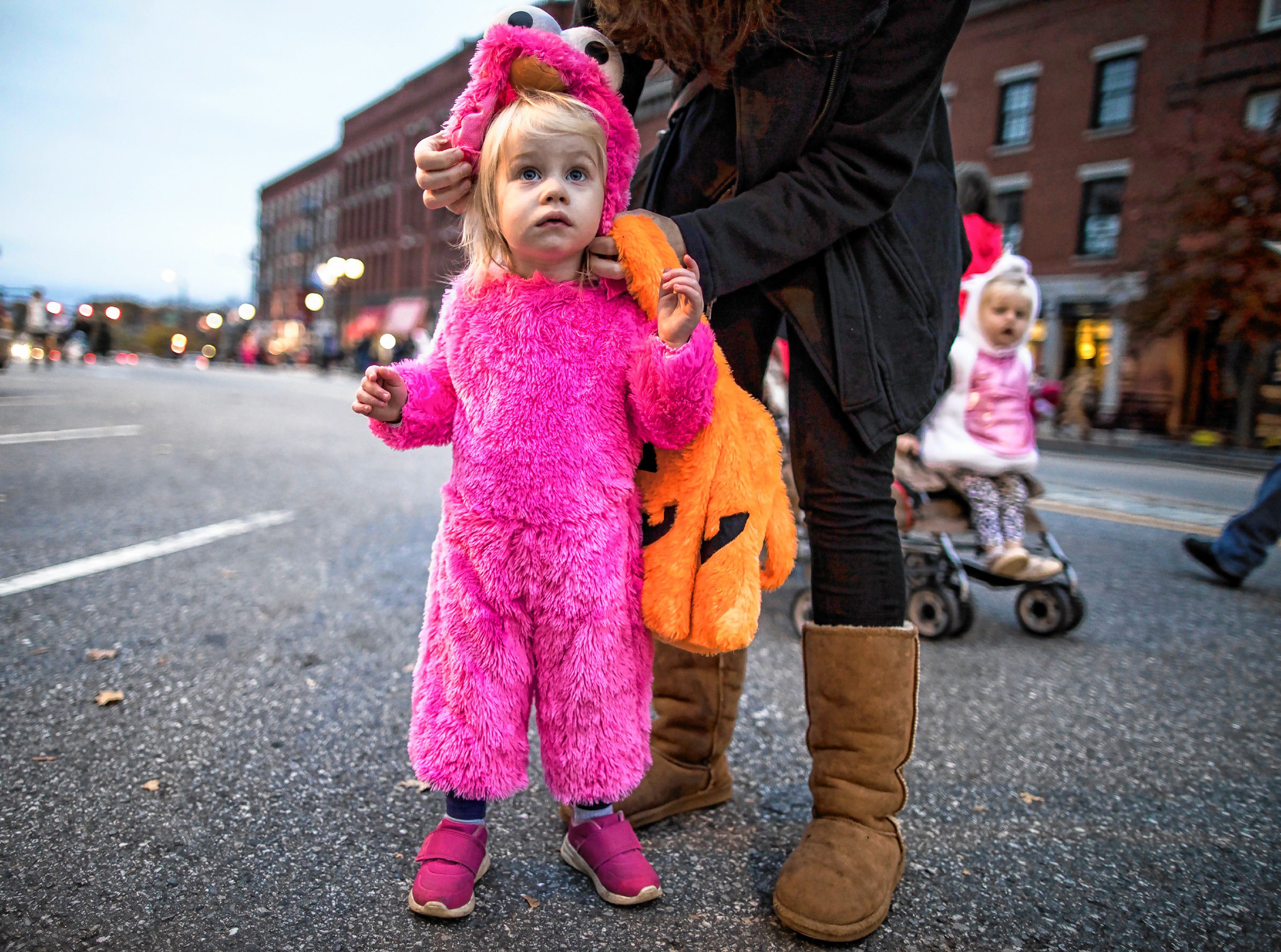 Allison Parkington, 2, gets her headress adjusted by her mom at the Halloween Howl on Main Street in Concord on Friday evening, October 25, 2019. GEOFF FORESTER