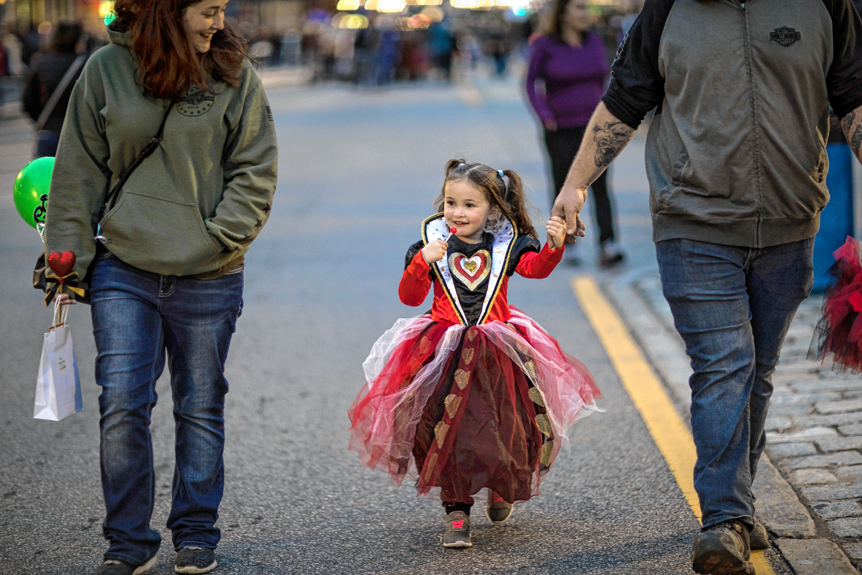 Elena Walker, 3, walks with her parents at the Halloween Howl in downtown Concord on Friday evening, October 25, 2019. GEOFF FORESTER