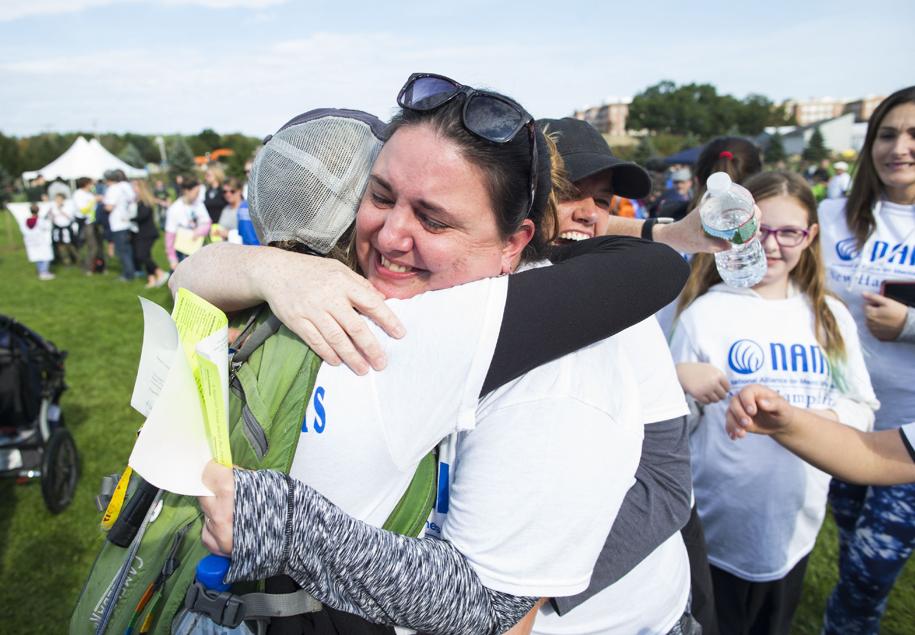 Heather Anderson of Hillsboro gets a hug after getting emotional after taking a group photo for Bonnieâs Soul Sisters in memory of her sister Bonnie who died in 2001 before the NAMI Walk on Sunday, September 30, 2018. GEOFF FORESTER