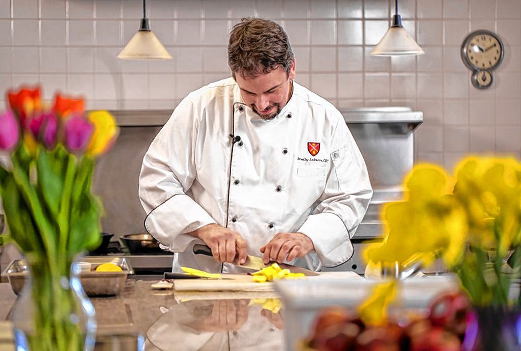 Bradley Labarre, rectory chef at St. Paul's School, demonstrates some of his skills on the job recently. Labarre will compete against two other Granite State chefs in the New Hampshire Food Bank Steel Chef Challenge in Manchester on March 11. Courtesy of Derek Thomson 