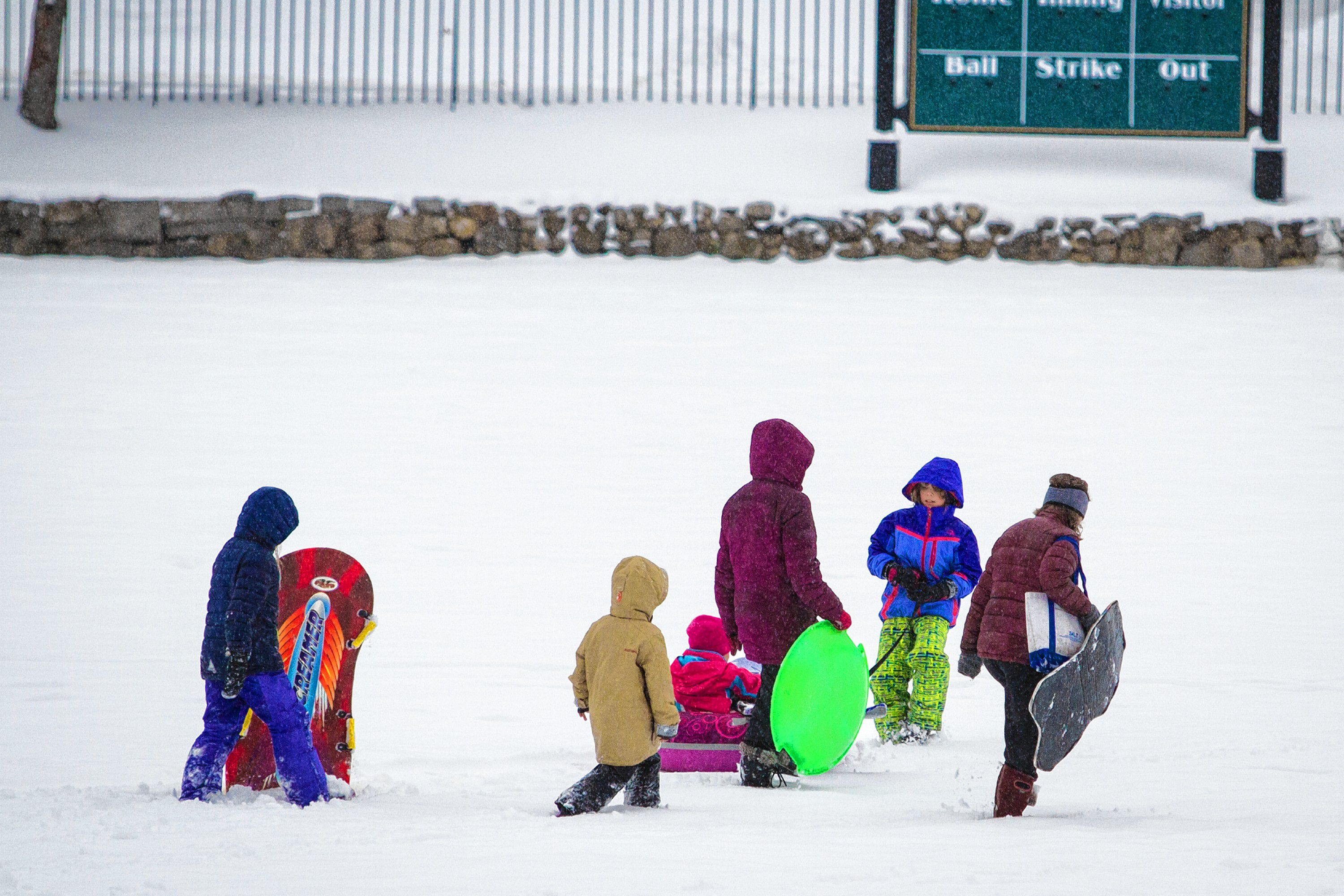 Students sled down a hill at White Park in Concord on Tuesday, Dec. 12, 2017. Luce, who attends Christa McAuliffe School, had a snow day and walked to the park with her mother. (ELIZABETH FRANTZ / Monitor staff) ELIZABETH FRANTZ