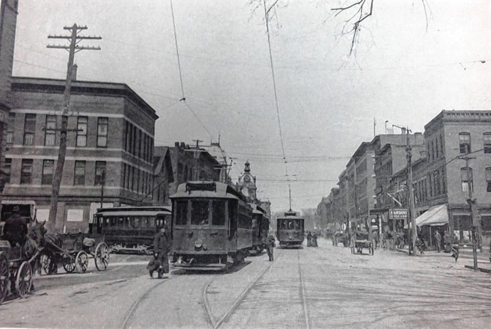 The old electric trolleys drive past the corner of Pleasant Street and Main Street in Concord. 