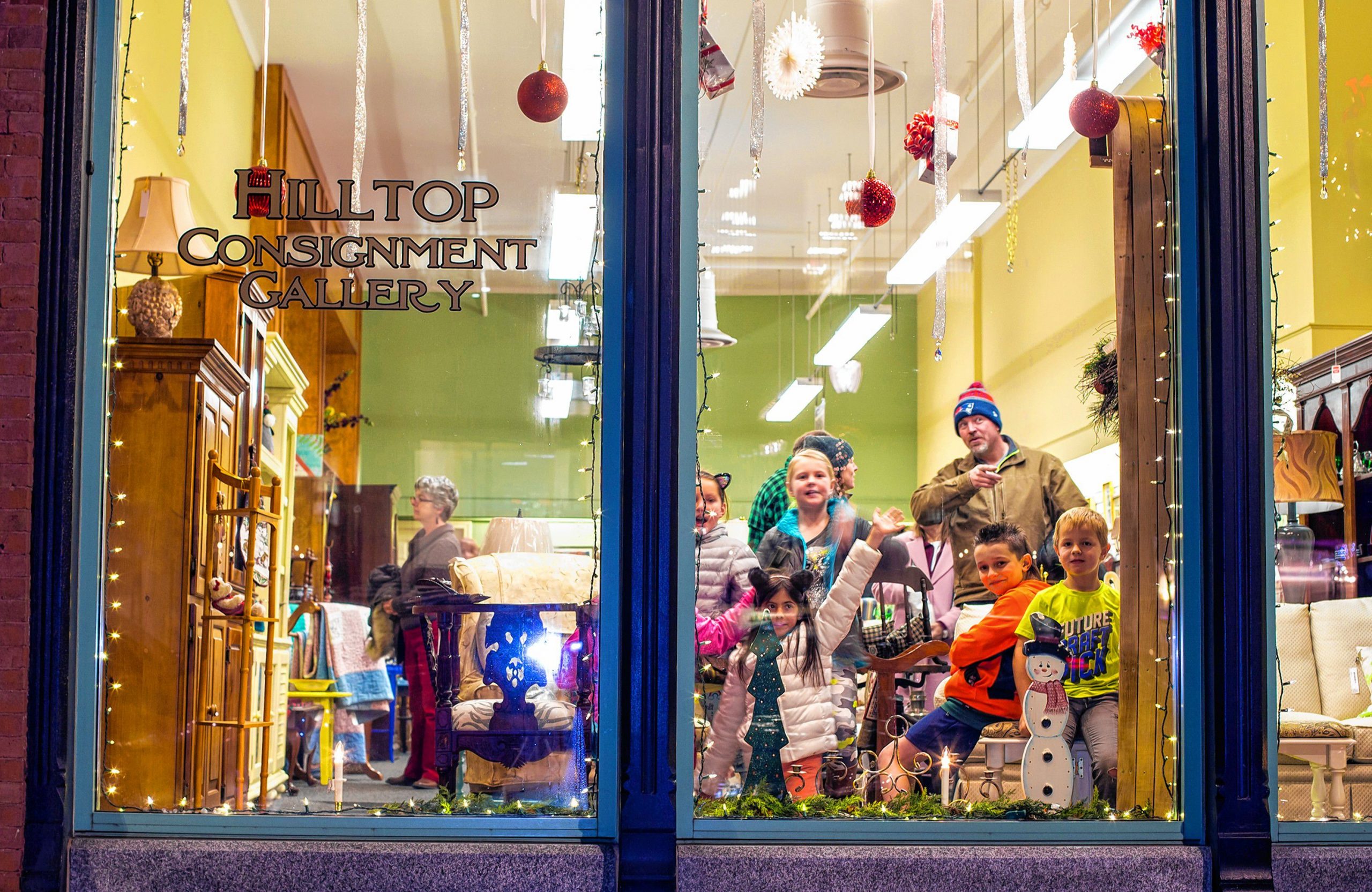 The Osmer and Soucie families and their friends check out the Hilltop Consignment Gallery on Main Street during Midnight Merriment in 2018. 