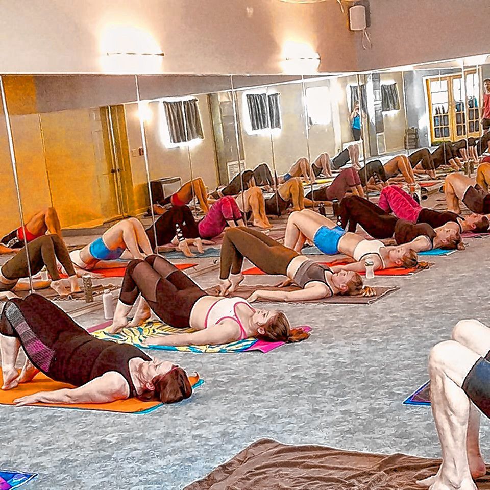 People practice yoga poses at Hot House Yoga. 