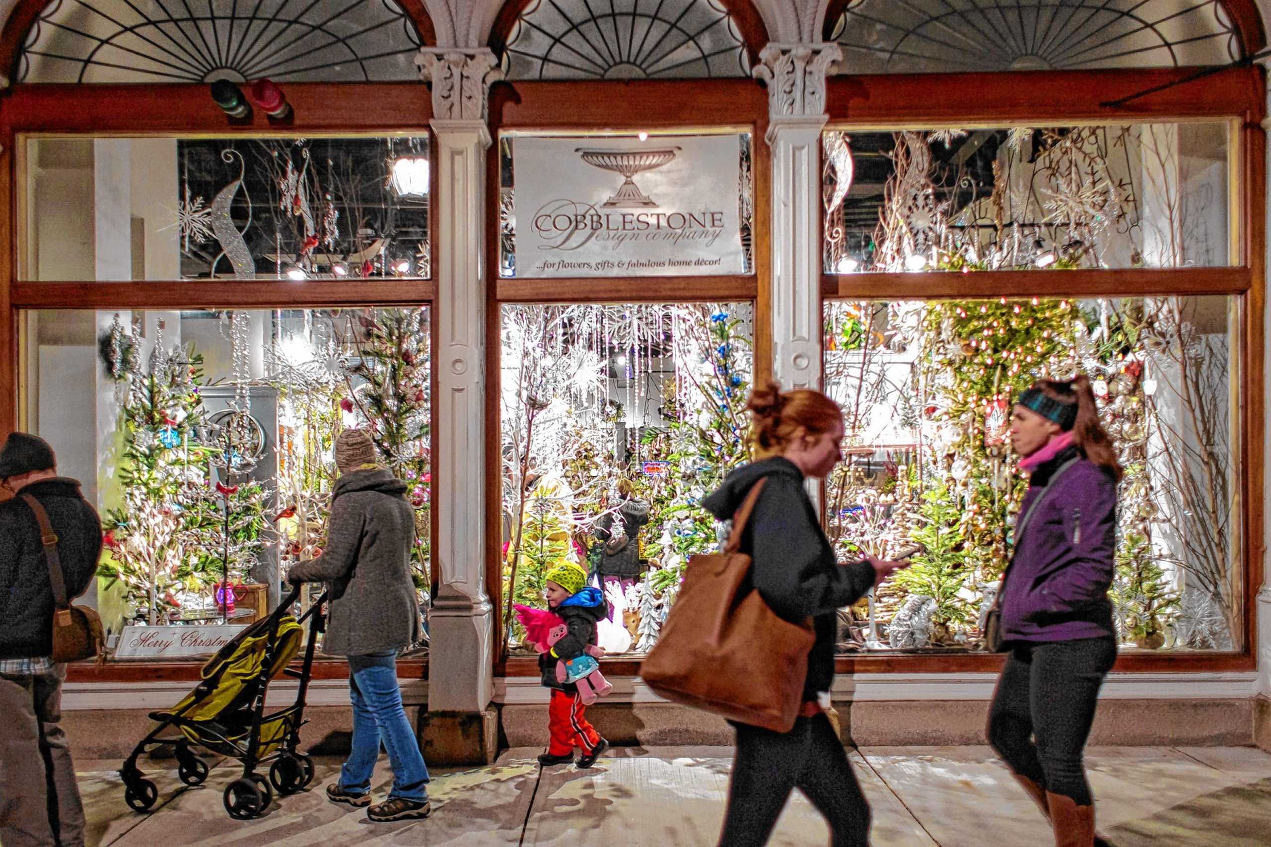 People walk past Cobblestone Design Company during Midnight Merriment in downtown Concord on Friday, Dec. 1, 2017. ELIZABETH FRANTZ