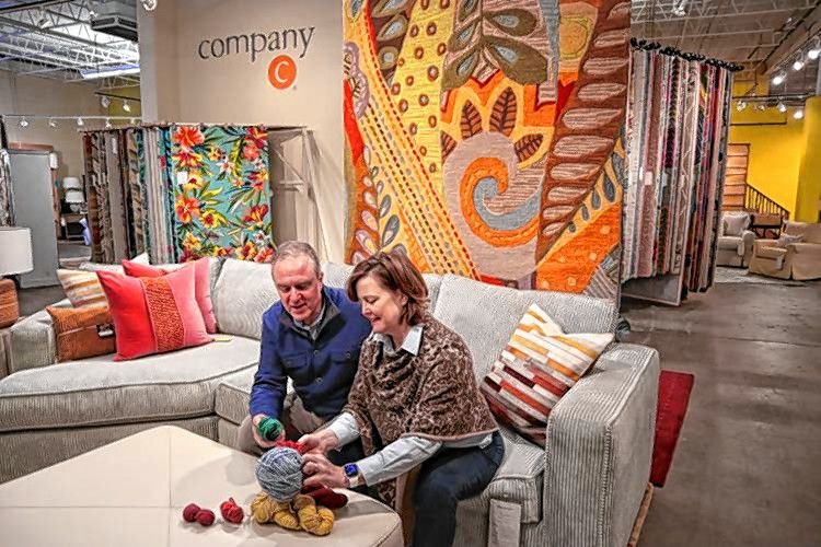 Company C co-founders Christine and Walter Chapin peruse through a rug display at their store on Old Turnpike Road in Concord in January. 