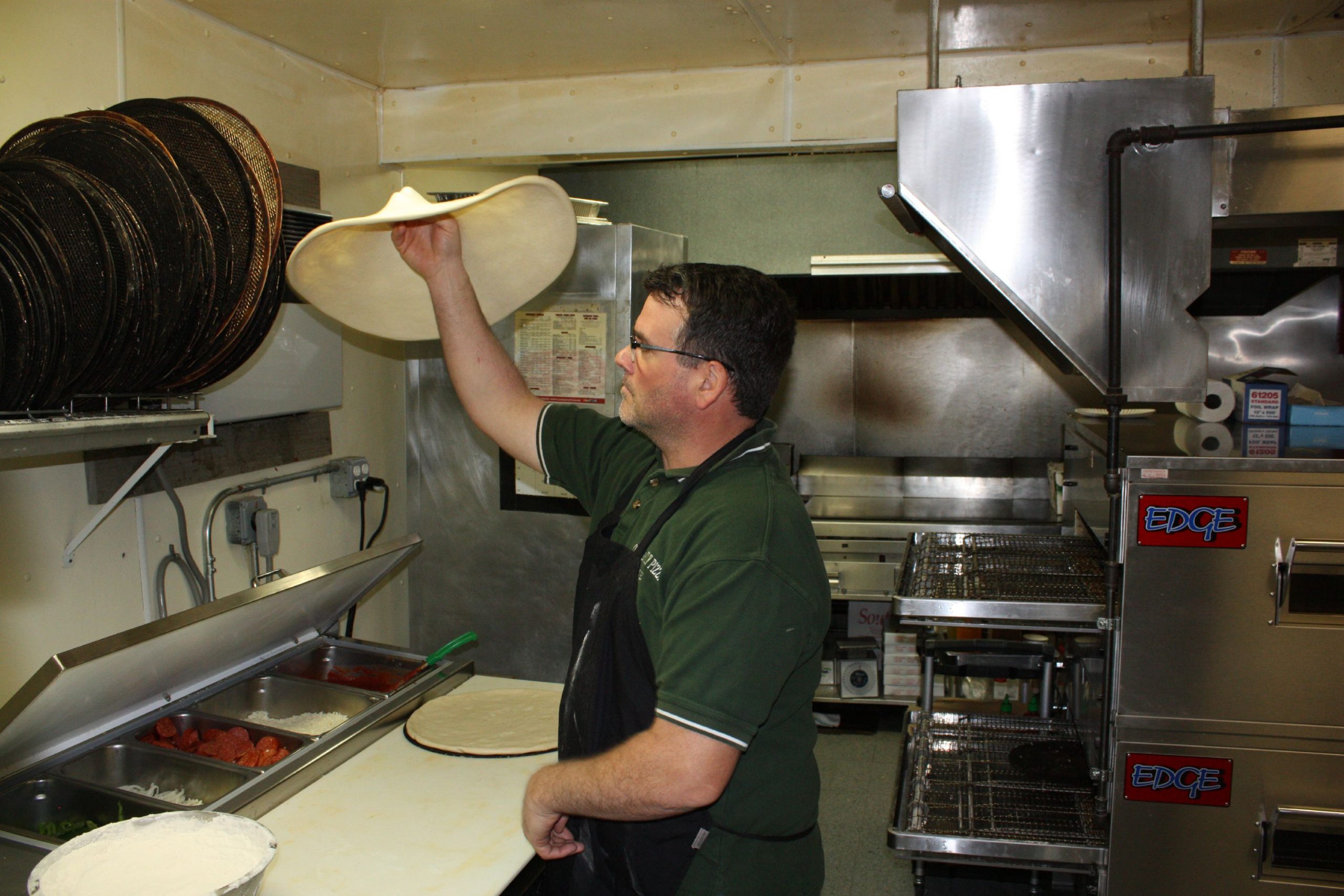 Constantly Pizza co-owner Dave Constant whips up a pepperoni pizza at the downtown location last week. Constant has been making pizza for so long now he can spin a dough on his finger like a Harlem Globetrotter does with a basketball. JON BODELL / Insider staff