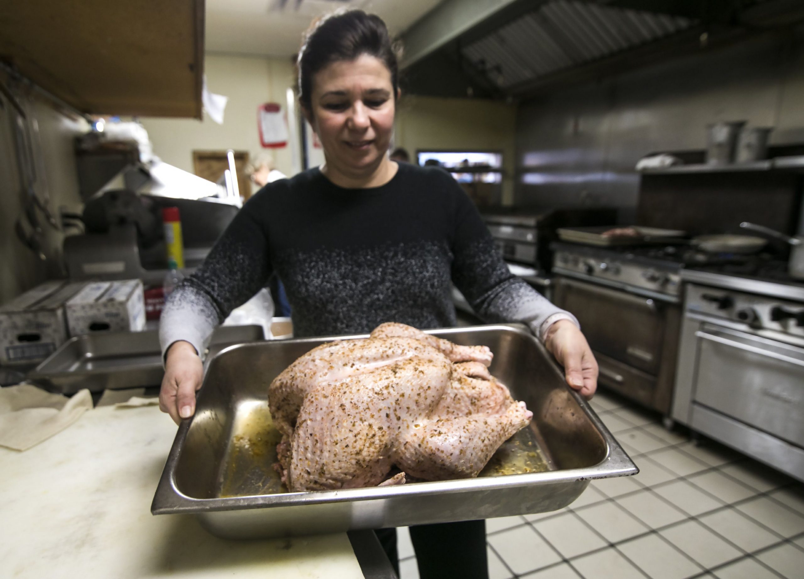 Sofia Smirnioudis holds the 71st turkey that the Windmill Restaurant will be cooking for their Turkey meal tradition at the restaurant as they prepare for the meals on Wednesday, November 27, 2019. Sofia and her husband Louis started the traiditon, paired with the Friendly Kitchen in offering meals to the homeless. His son, Kosmas and then entire family get all ready for the 1,000 people expected. GEOFF FORESTER