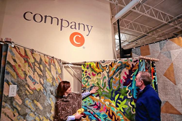 Company C co-founders Christine and Walter Chapin peruse through a rug display at their store on Old Turnpike Road in Concord in January. 