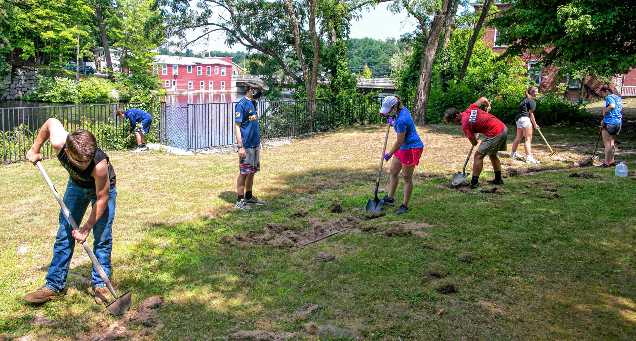 Connor Baldwin (center) walks through Riverside Park in Penacook as he leads his group of friends on the clean up of the area in downtown Penacook on Tuesday, August 11, 2020. GEOFF FORESTER