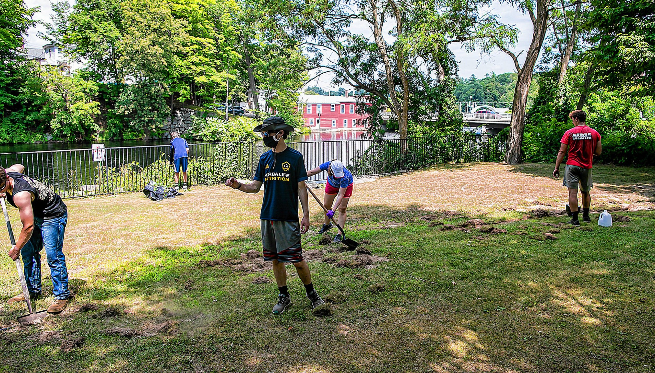 Connor Baldwin (center) walks through Riverside Park in Penacook as he leads his group of friends on the clean up of the area in downtown Penacook on Tuesday, August 11, 2020. GEOFF FORESTER