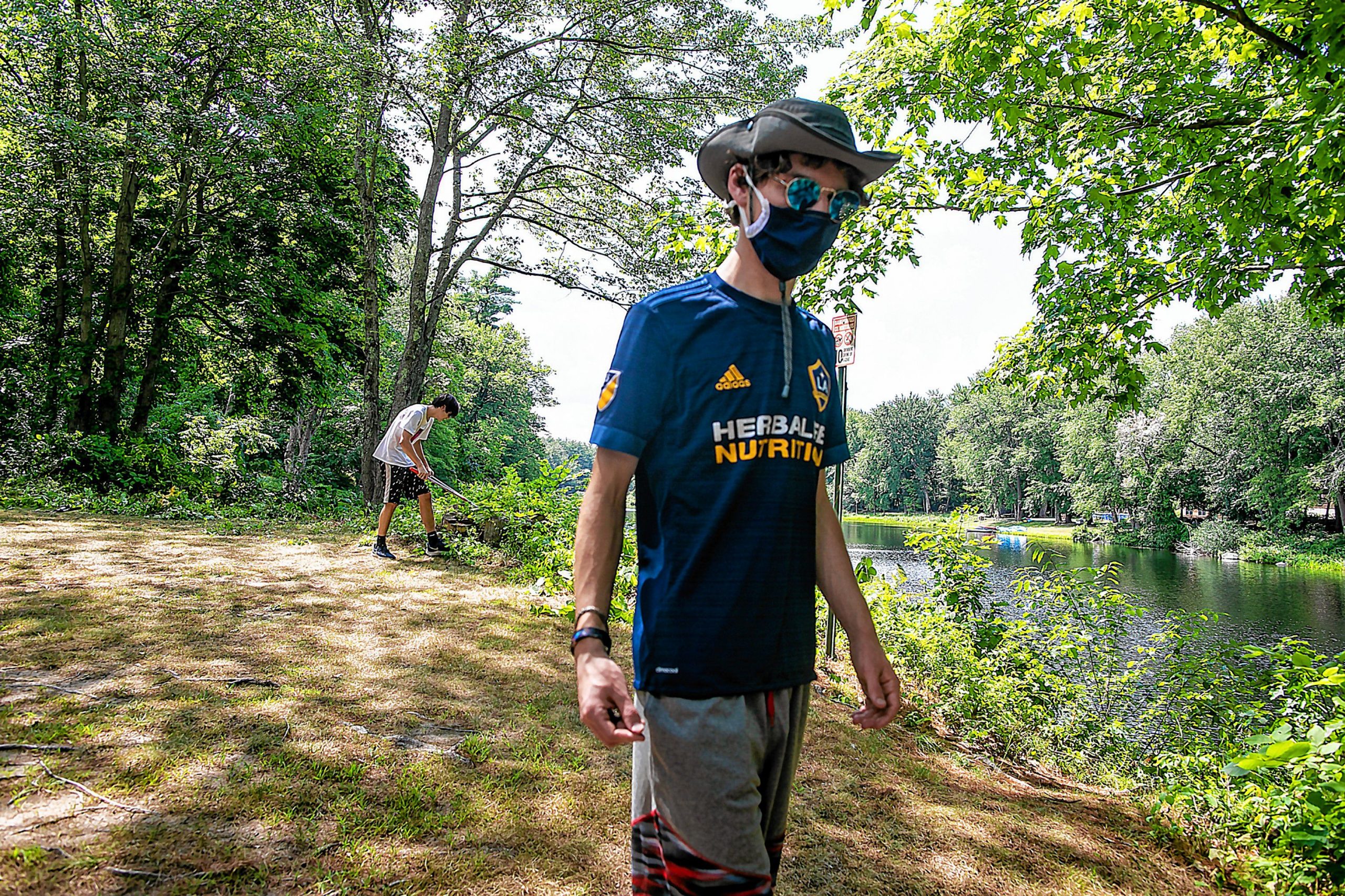 Connor Baldwin walks through Riverside Park in Penacook as he leads his group of friends on the clean up of the area on Tuesday, August 11, 2020. GEOFF FORESTER