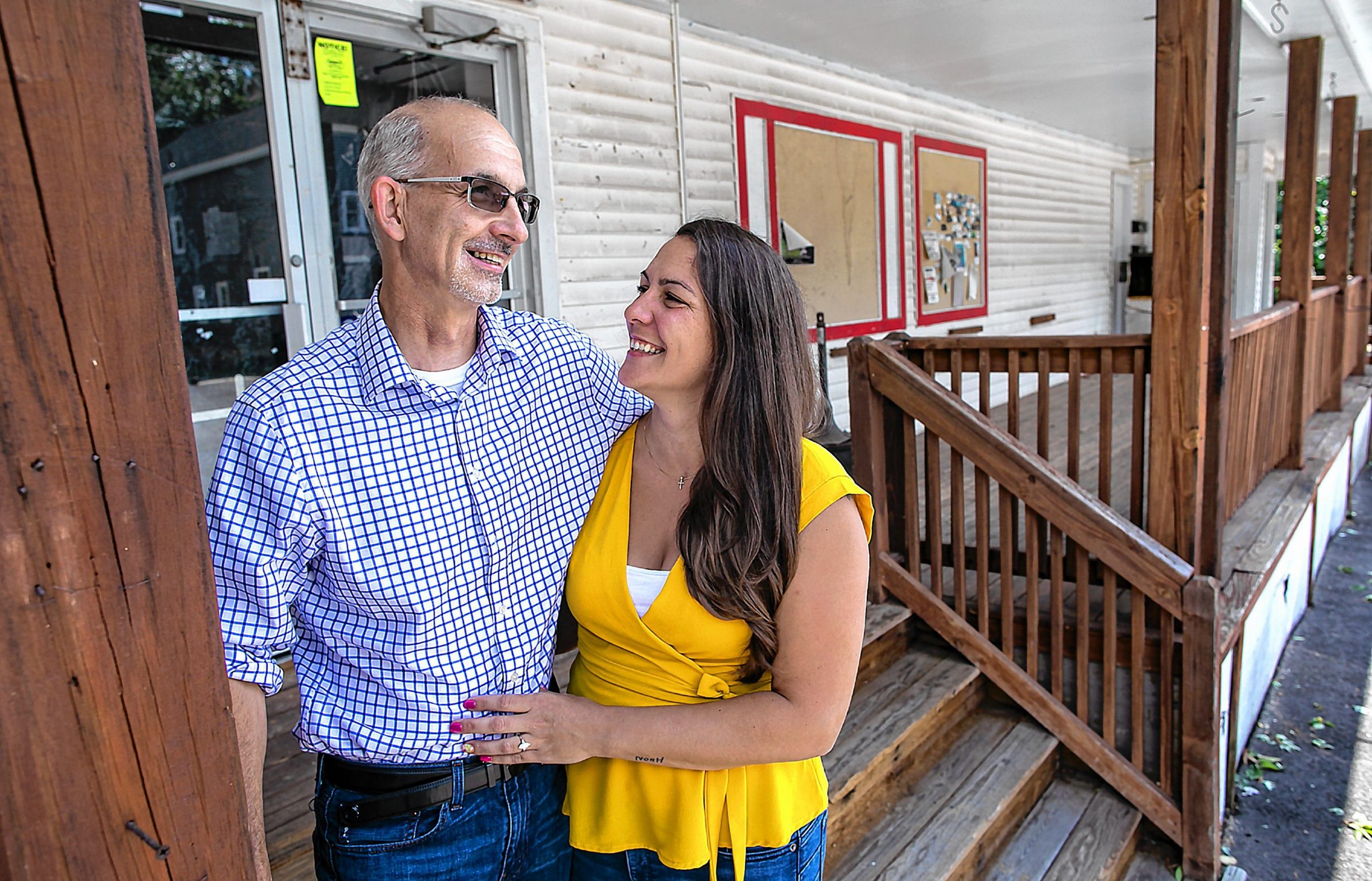 Dave McLaughlin of Allenstown and co-owner fiance Tiffani McIntosh stand at the steps outside of the former Quality Cash Market in East Concord on Wednesday, August 5, 2020. The owners hope to open the new neighborhood market by mid-September to the first of October. GEOFF FORESTER