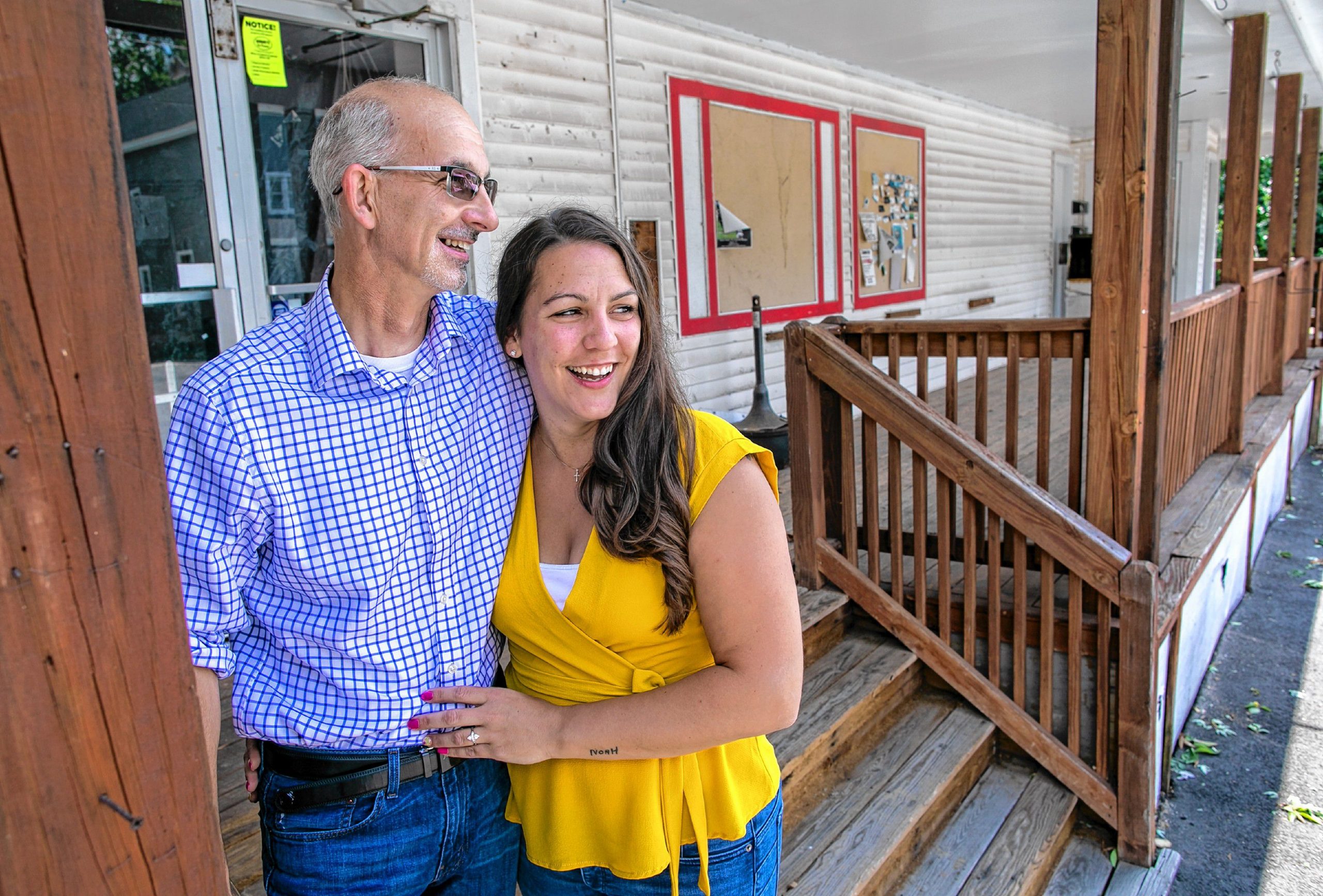 Dave McLaughlin of Allenstown and co-owner fiance Tiffani McIntosh stand at the steps outside of the former Quality Cash Market in East Concord on Wednesday, August 5, 2020. The owners hope to open the new neighborhood market by mid-September to the first of October. GEOFF FORESTER