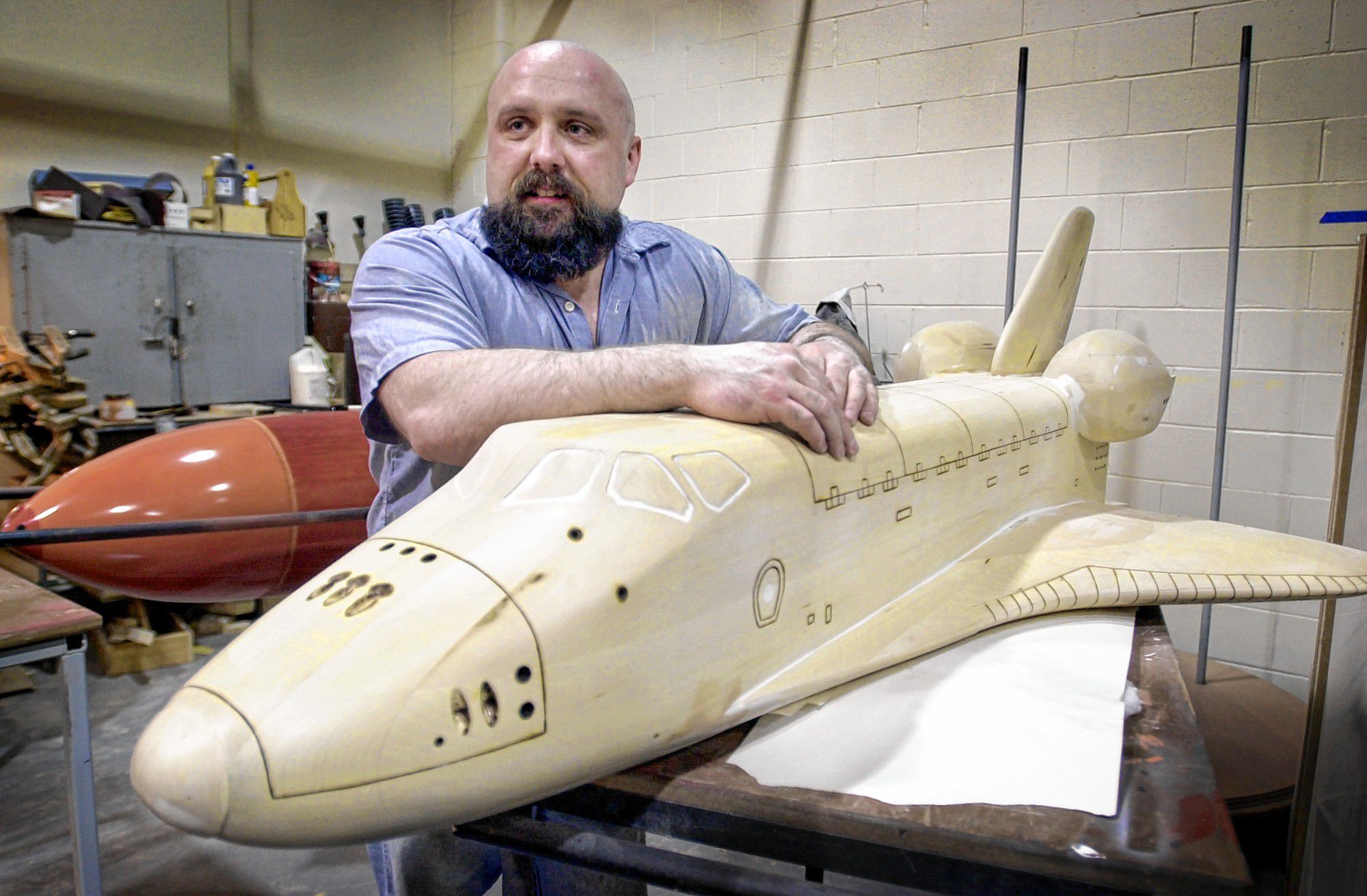 Maine State Prison inmate Rod Whitten takes a break while working on a new a model of the space shuttle Challenger in the prison woodworking shop on May 20, 2004 in Warren, Maine. Whitten's shuttle is to be placed on permanent display at the Christa McAuliffe Planetarium in Concord. AP