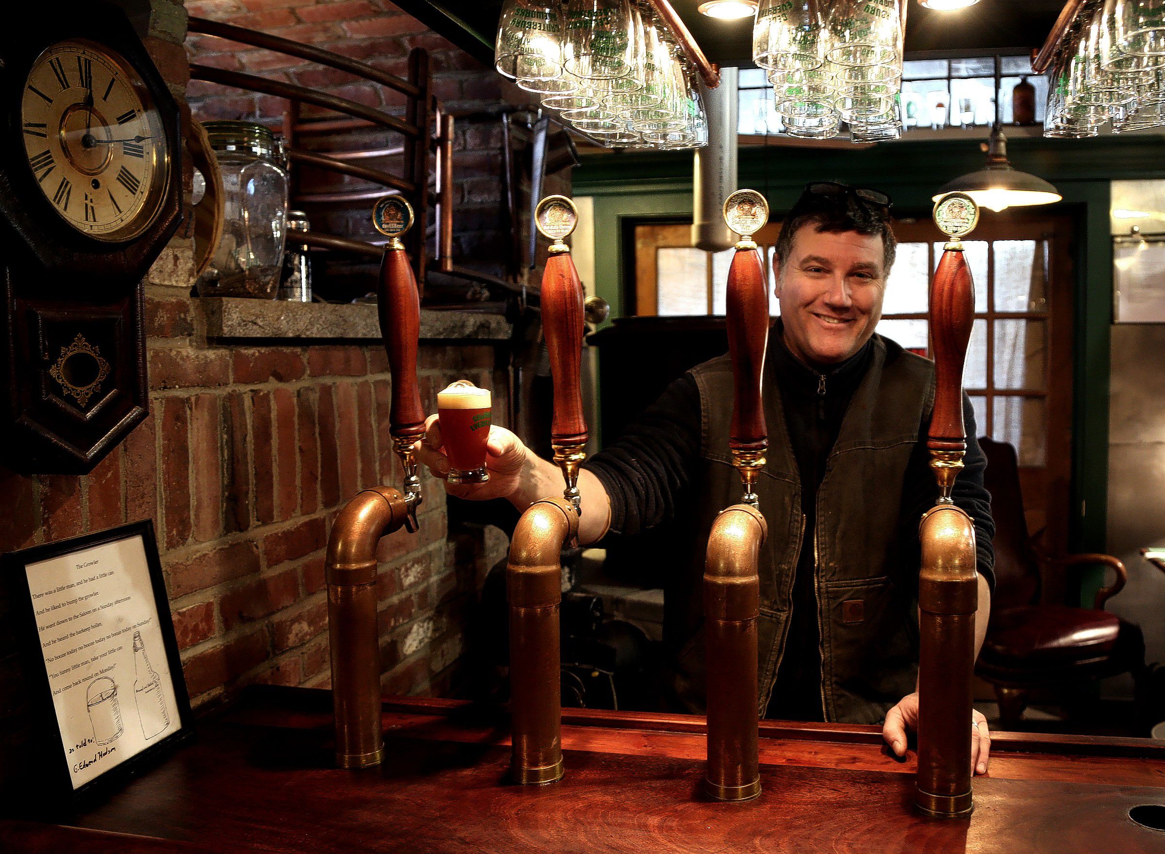 Steve Allman, brewer and owner of Canterbury Aleworks holds up a sample of one of his brews. (GEOFF FORESTER / Monitor staff) 