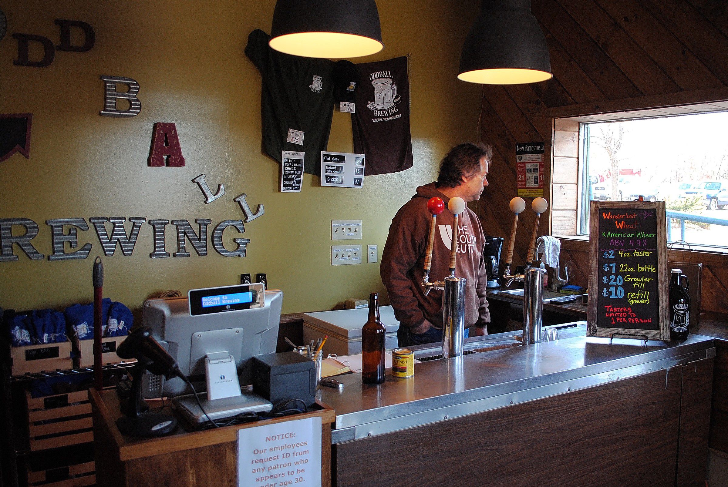 Mark Ferguson of Chichester peers out the front window of Oddball Brewing Co. in Suncook on Wednesday. 