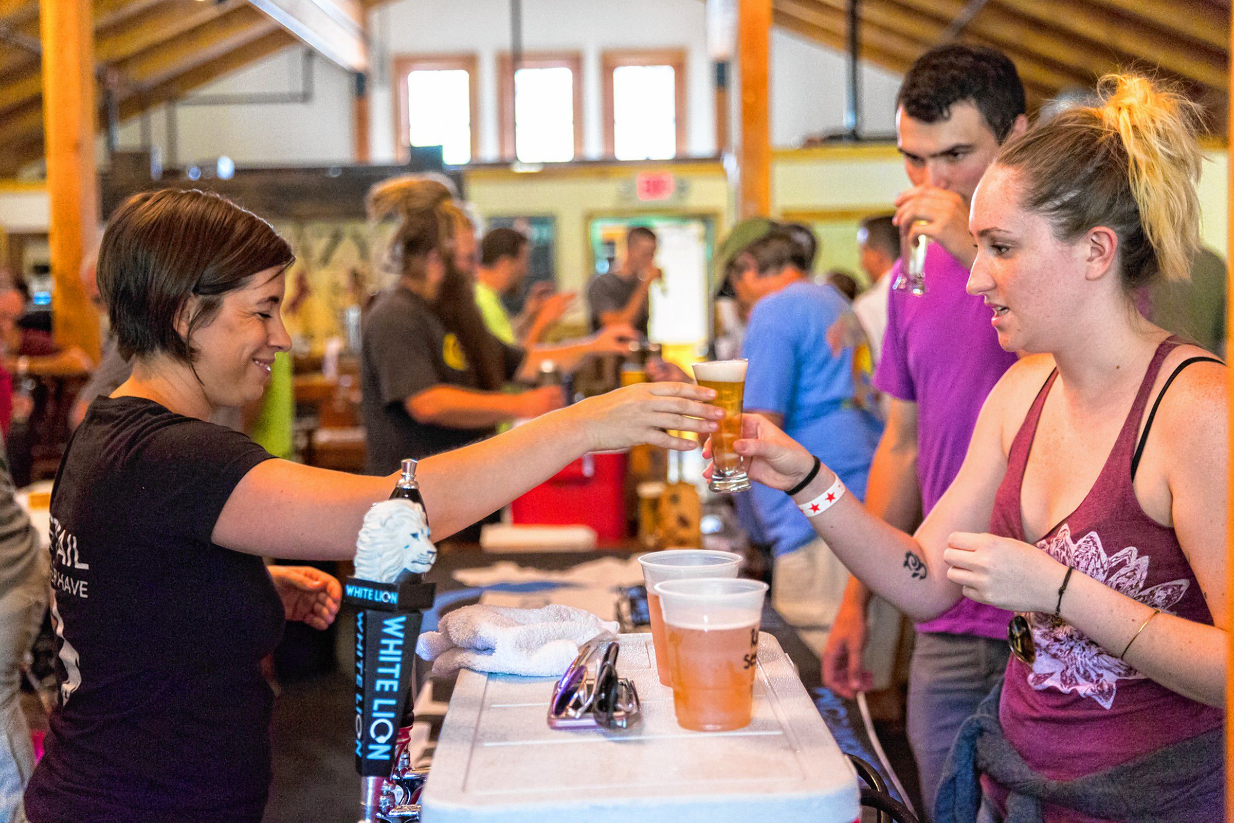 Ashley Clark, of White Lion brewery in Springfield, serves a beer to an attendee of Franklin County Beer Fest at Berkshire East in Charlemont Saturday, July 22, 2017. Recorder Staff/Matt Burkhartt