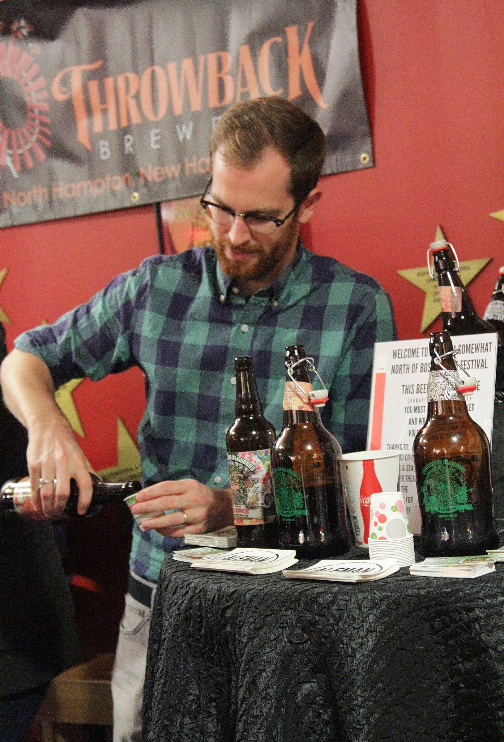 Aiden Redmon of Canterbury Aleworks pours a sample in the lobby of Red River Theatres on Thursday, Nov. 6, 2014. The Concord Co-op hosted a beer tasting and food event to kick off the SNOB Film Festival on Thursday evening. (Breaking news: it was yummy.) This page, top left: Glasses and mugs with the SNOB logo emblazoned on them. That must be where we got the template for the new tattoo we have but don’t remember getting this weekend. Top right: Aiden Redmon of Canterbury Aleworks pours a sample. For his homies. Facing page, top: Jim Tyrrell, self-described singer, songwriter and hooligan, performed for the crowd. Middle: Throwback Brewery was represented by Christopher Naro, assistant brewer. Bottom: It may have been raining beer inside, but it was raining actual rain outside.   