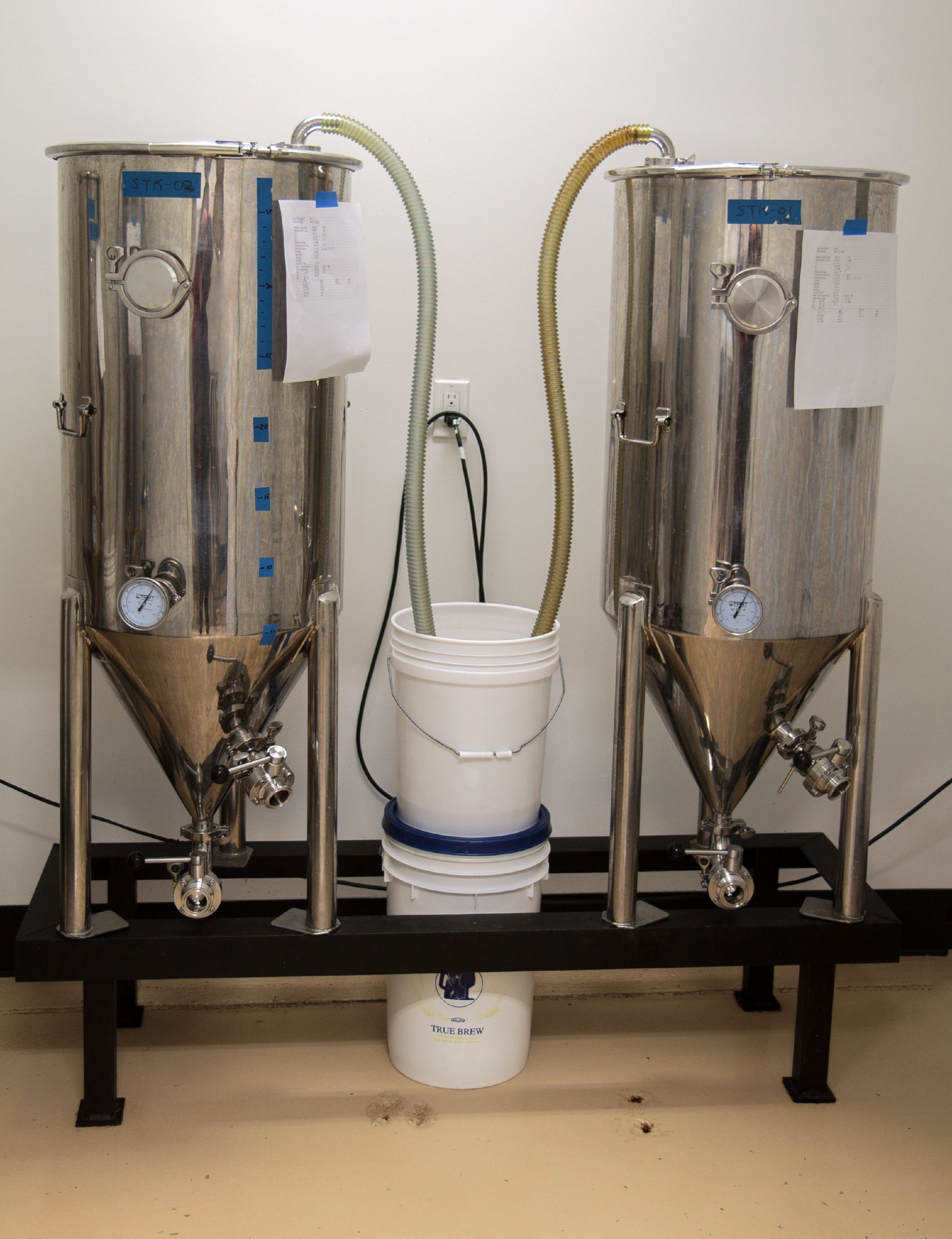 Two of the fermenters that Head Brewer Tom Albright uses to brew the beers that you can find at Out Haus Ales and local shops. (JENNIFER MELI / Monitor Staff) 