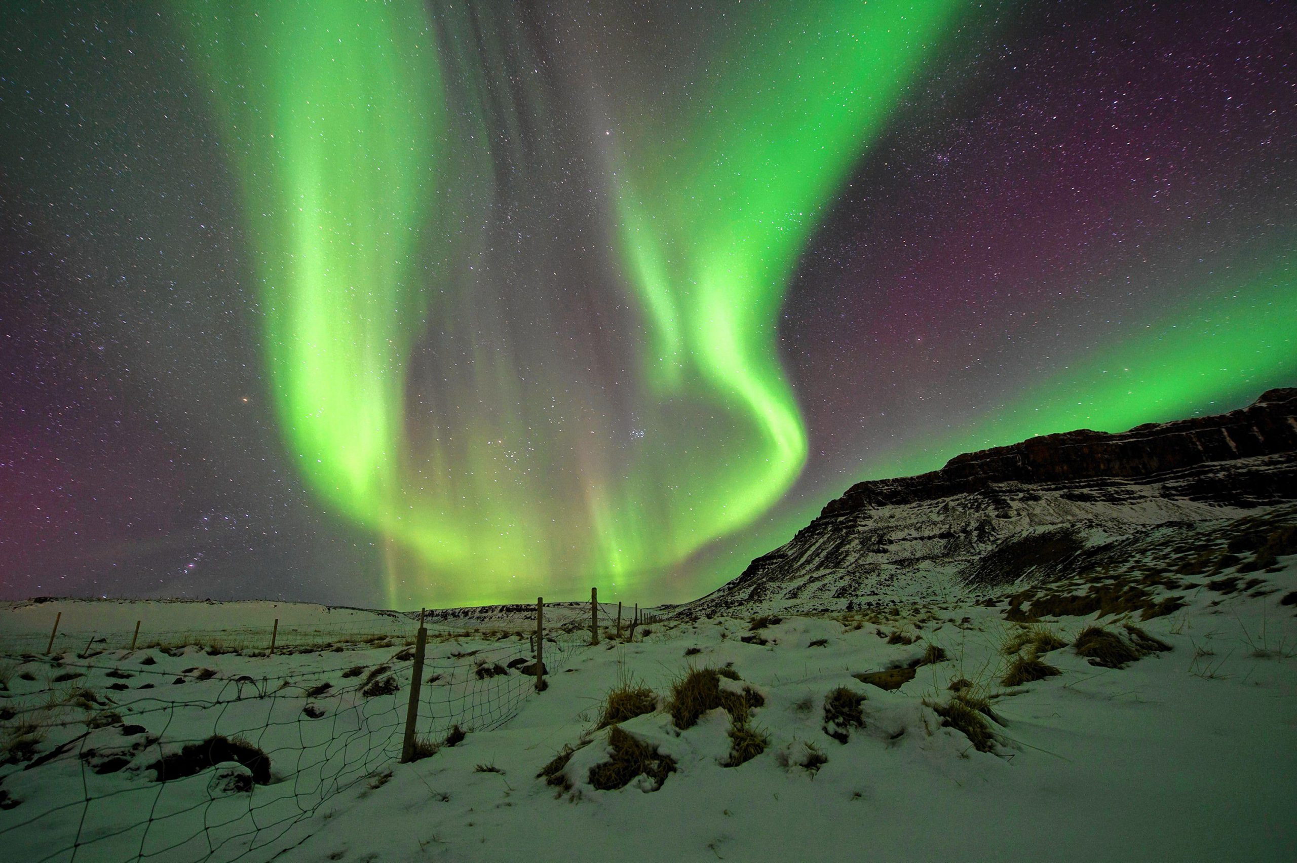 FILE - In this March 1, 2017 file photo, the Northern Lights, or aurora borealis, appear in the sky over Bifrost, Western Iceland. Police in Iceland say tourists are often putting themselves at risk searching for the Northern Lights, whose spectacular streaks of color light up the winter skies at night. Police say sleep-deprived tourists are dividing their attentions between the road and the sky, and often underestimate the challenging conditions posed by Iceland’s twisty, narrow, often-icy roads in the winter. (AP Photo/Rene Rossignaud, File) Rene Rossignaud