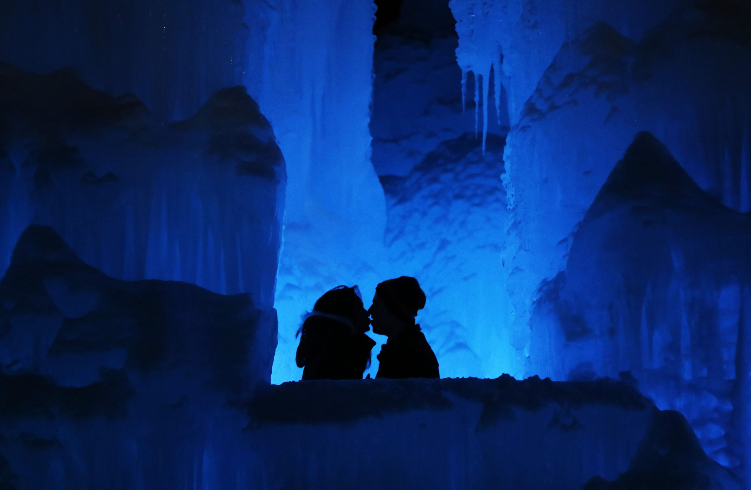 In this Friday, Jan. 25, 2019 photo, a couple enjoy the Ice Castles in North Woodstock, N.H. "It's a really popular date night spot," said castle builder Matt Pasciuto. "I can't tell you how many marriage proposals I've seen so far in the castle." (AP Photo/Robert F. Bukaty)  Robert F. Bukaty