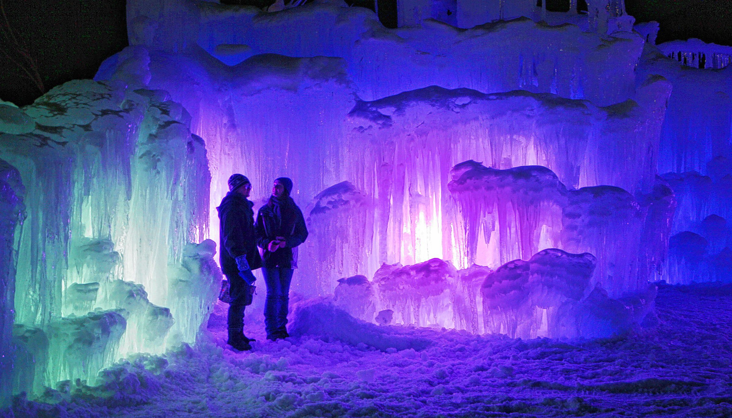 In this Wednesday, Jan. 8, 2014 photo, patrons tour an ice castle at the base of the Loon Mountain ski resort in Lincoln, N.H. The ice castle begins to grow in the fall when the weather gets below freezing and thousands of icicles are made and harvested then placed around sprinkler heads and sprayed with water.  The castle will continue to grow as long as the temperatures stay below freezing. (AP Photo/Jim Cole) Jim Cole