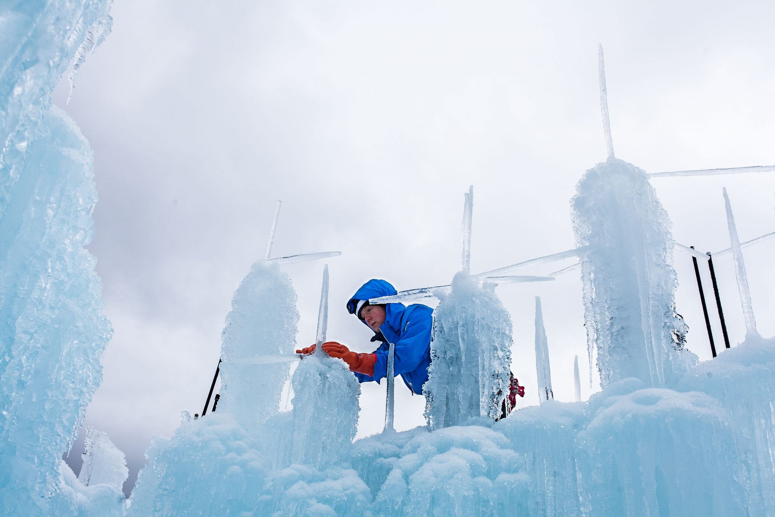 Sherri Covell of Ashland fuses icicles to the top of an in-progress ice tower at Ice Castles in Lincoln on Tuesday, Dec. 19, 2017. (ELIZABETH FRANTZ / Monitor staff) Elizabeth Frantz