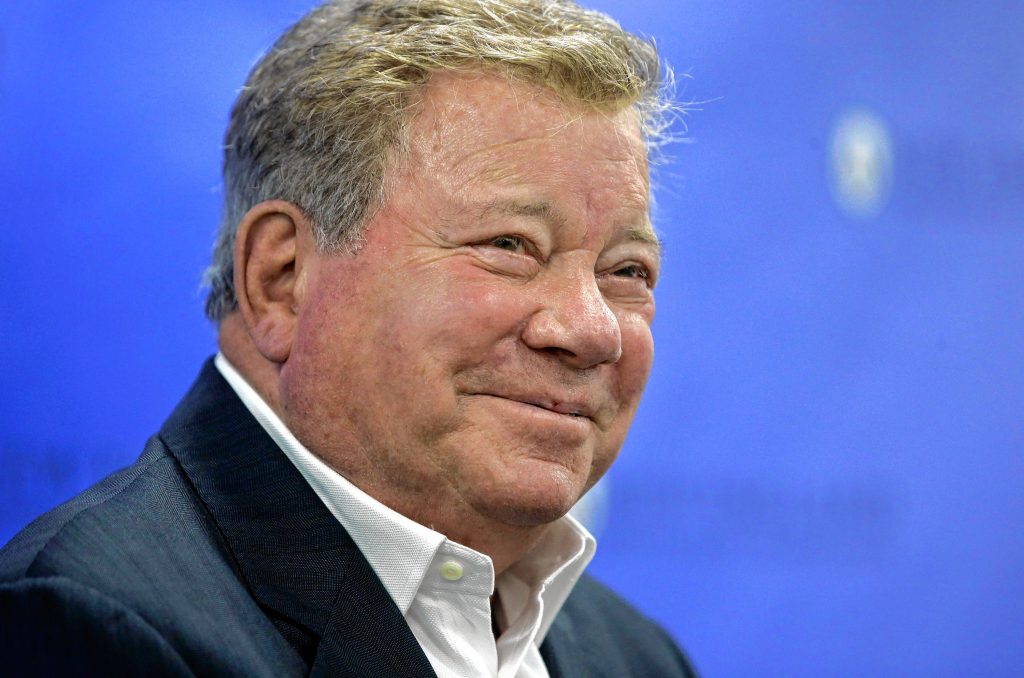 FILE - In this May 6, 2018 file photo, actor William Shatner takes questions from reporters after delivering the commencement address at New England Institute of Technology graduation ceremonies, in Providence, R.I. Star Trek’s Captain Kirk is rocketing into space this month — boldly going where no other sci-fi actors have gone. Jeff Bezos’ space travel company, Blue Origin, announced Monday, Oct. 4, 2021 that Shatner will blast off from West Texas on Oct. 12.  (AP Photo/Steven Senne, file) Steven Senne