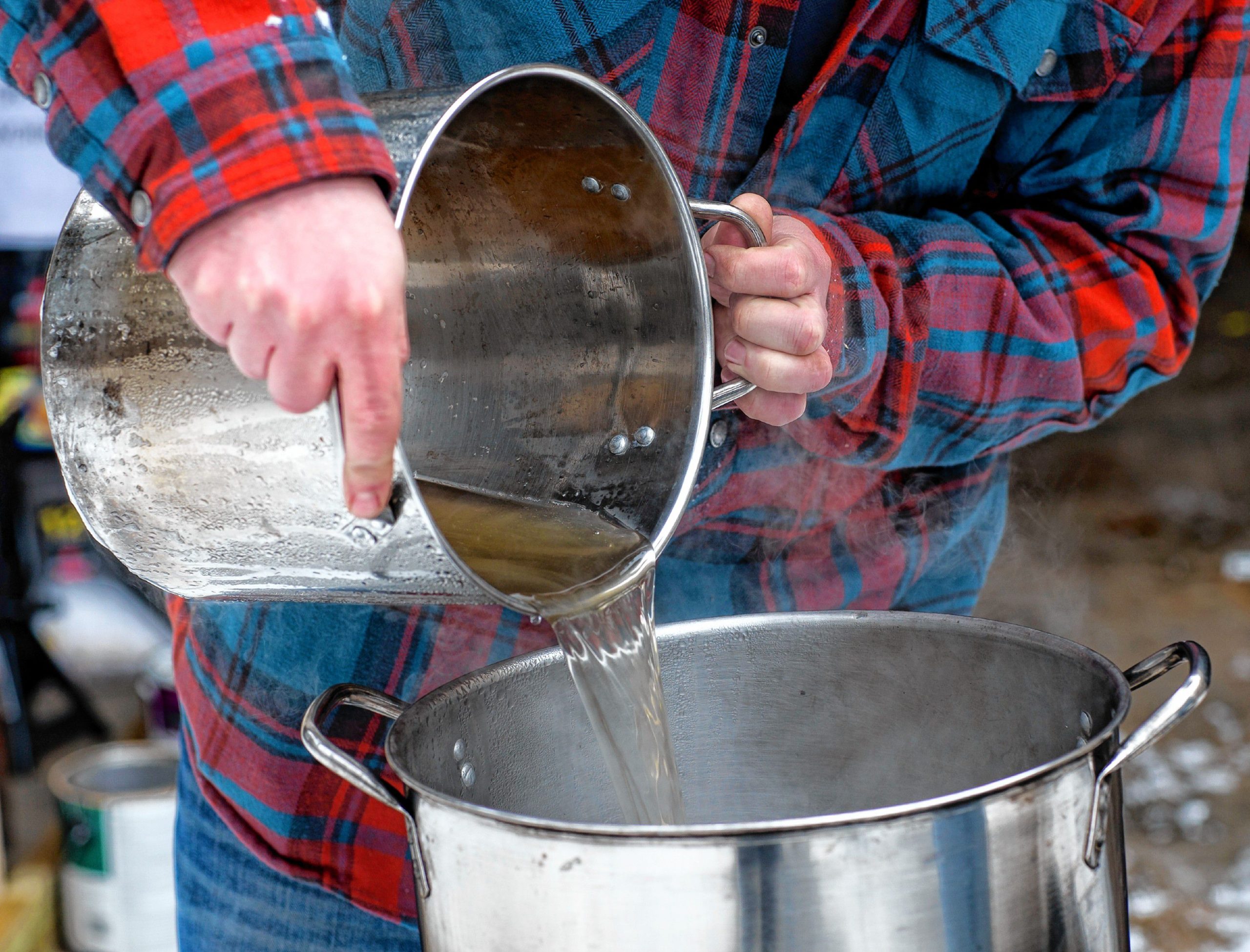 Andrew Mattiace pours out some sap for his syruping operation at his Bow home on Saturday, March 2, 2019. GEOFF FORESTER