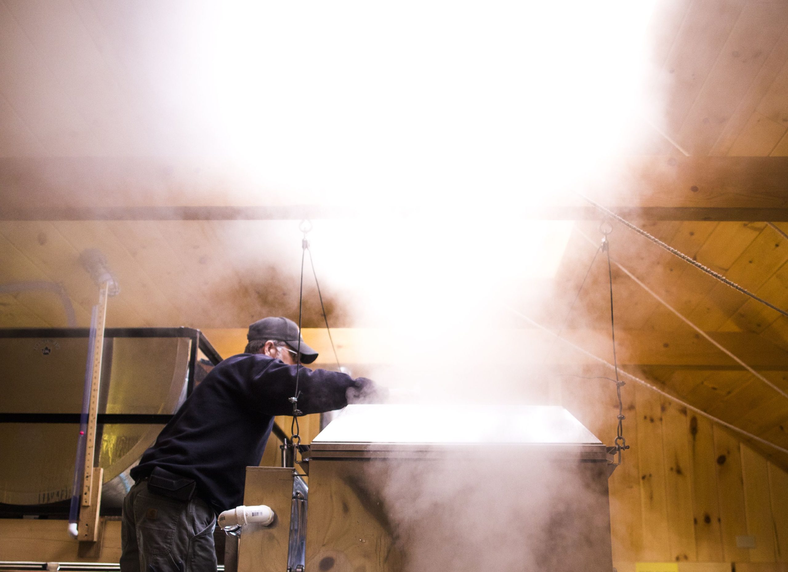 Mike Moore, owner of Sunnyside Maples in Loudon, checks on the foam buildup in his evaporator on Thursday, March 21, 2019 as he prepares for the Maple Weekend. GEOFF FORESTER