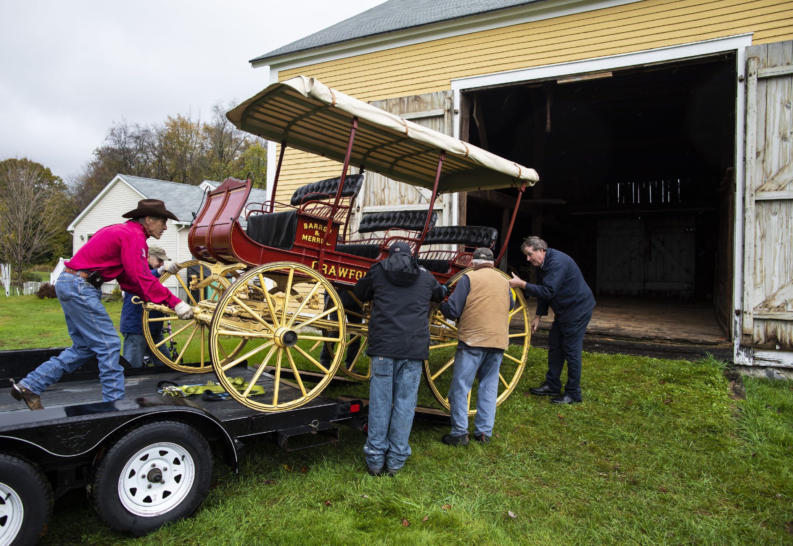 With the help of the Penacook Historical Society, the Abbot-Downing Historical Society was able to store of its eight 19th century coaches and carriages at the Rolfe Barn on Penacook Street on Tuesday, October 27, 2021. The members of the Abbot-Downing Historical Society roll one of the carriages off the flatbed to be put in the barn. GEOFF FORESTER